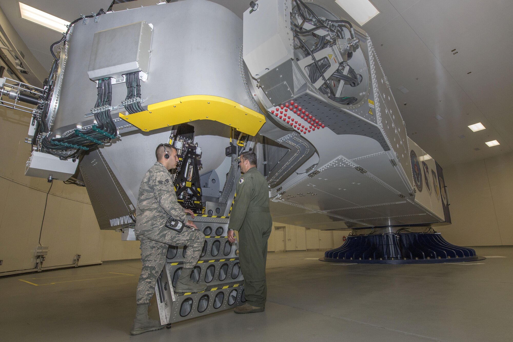 U.S. Air Force School of Aerospace Medicine operational physiology technicians, Senior Airman Luciano Cattaneo and Tech. Sgt. Adam Tyler, prepare to climb into the training centrifuge at Wright-Patterson Air Force Base, Ohio, April 26, 2017.  The purpose of the centrifuge is to provide optimum physical conditioning, appropriate functioning of anti-G equipment, and adequate G-oriented situational awareness for aircrew G-tolerance. (U.S. Air Force photo/Michelle Gigante)