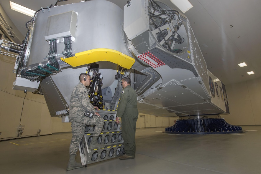 U.S. Air Force School of Aerospace Medicine operational physiology technicians, Senior Airman Luciano Cattaneo and Tech. Sgt. Adam Tyler, prepare to climb into the training centrifuge at Wright-Patterson Air Force Base, Ohio, April 26, 2017.  The purpose of the centrifuge is to provide optimum physical conditioning, appropriate functioning of anti-G equipment, and adequate G-oriented situational awareness for aircrew G-tolerance. (U.S. Air Force photo/Michelle Gigante)