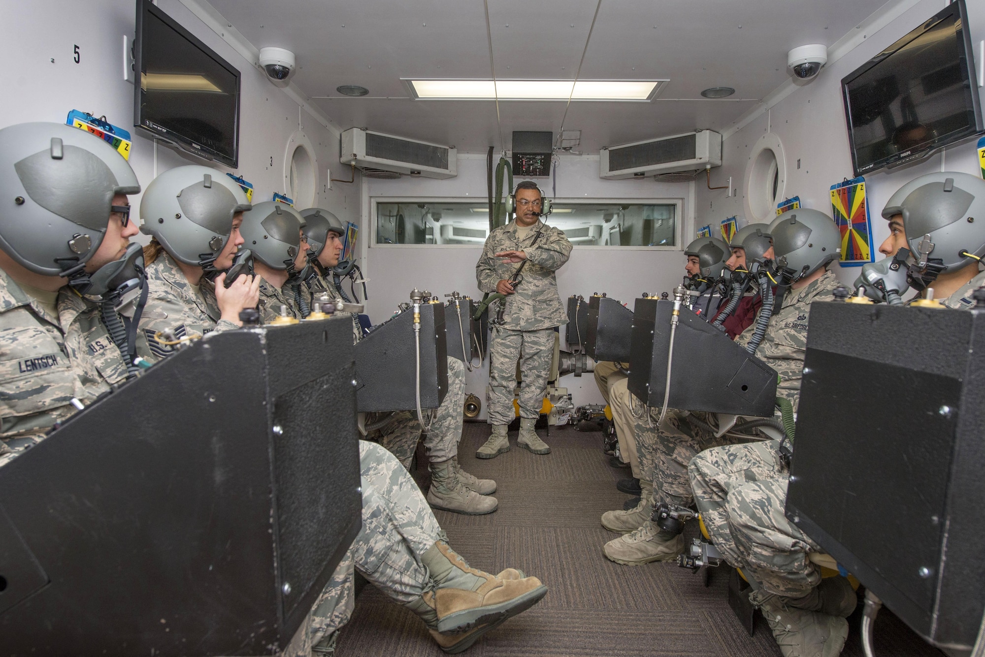 U.S. Air Force Senior Master Sgt. Paul Johal, School of Aerospace Medicine operational physiology superintendent, briefs students in the altitude hypobaric chamber about familiarizing themselves with the oxygen equipment for USAFSAM hypoxia demo training at Wright-Patterson Air Force Base, Ohio, April 26, 2017. The hypobaric chamber provides a training system which replicates the effects of barometric pressure change on the human body. (U.S. Air Force photo/Michelle Gigante)
