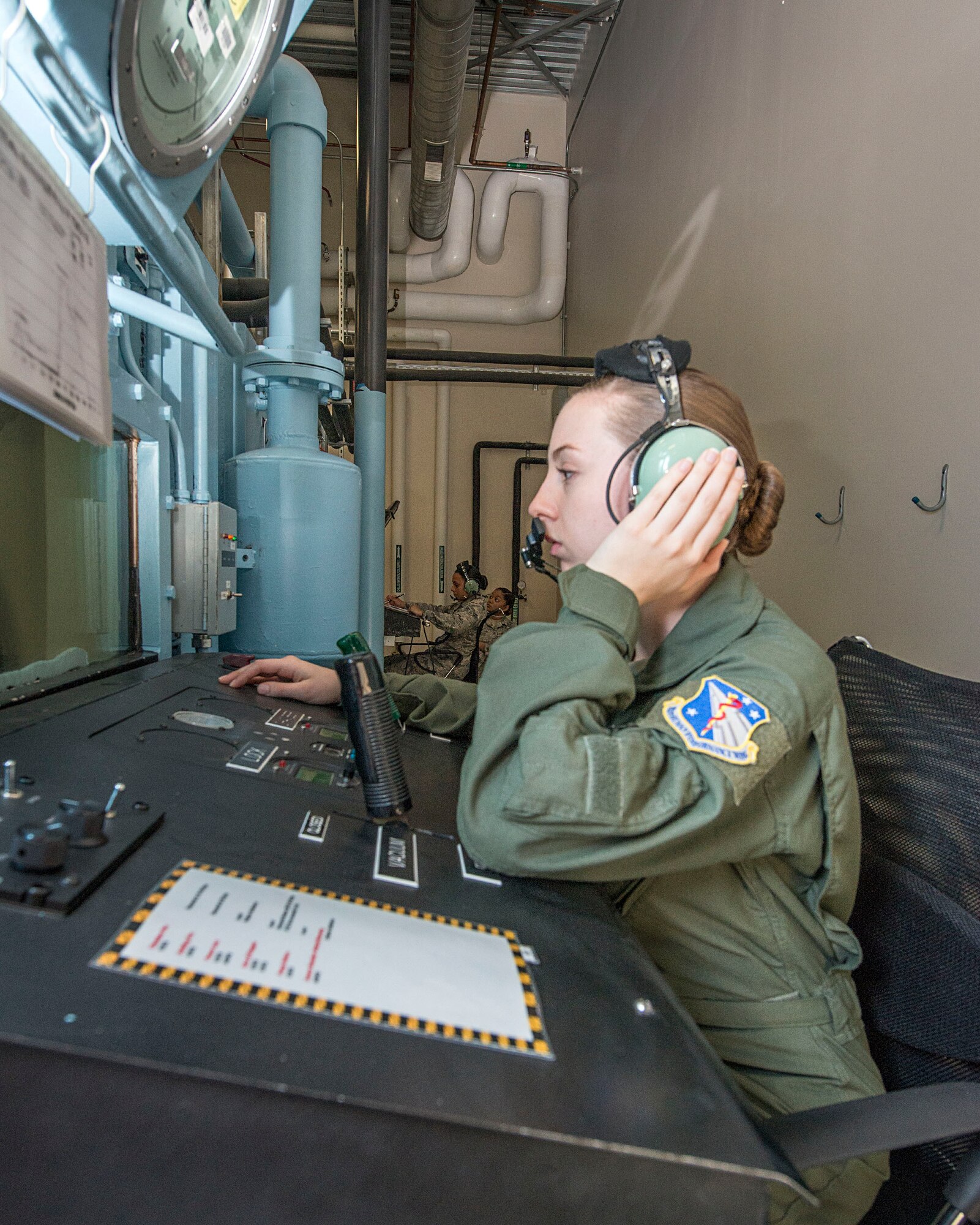 U.S. Air Force Airman 1st Class Jenna Dotson, USAF School of Aerospace Medicine operational physiology technician, monitors the altitude hypobaric chamber prior to the start of hypoxia demo training at Wright-Patterson Air Force Base, Ohio, April 26, 2017. The ability to simulate an aircraft rapid decompression provides valuable training experience for aircrew and parachutists. (U.S. Air Force photo/Michelle Gigante)