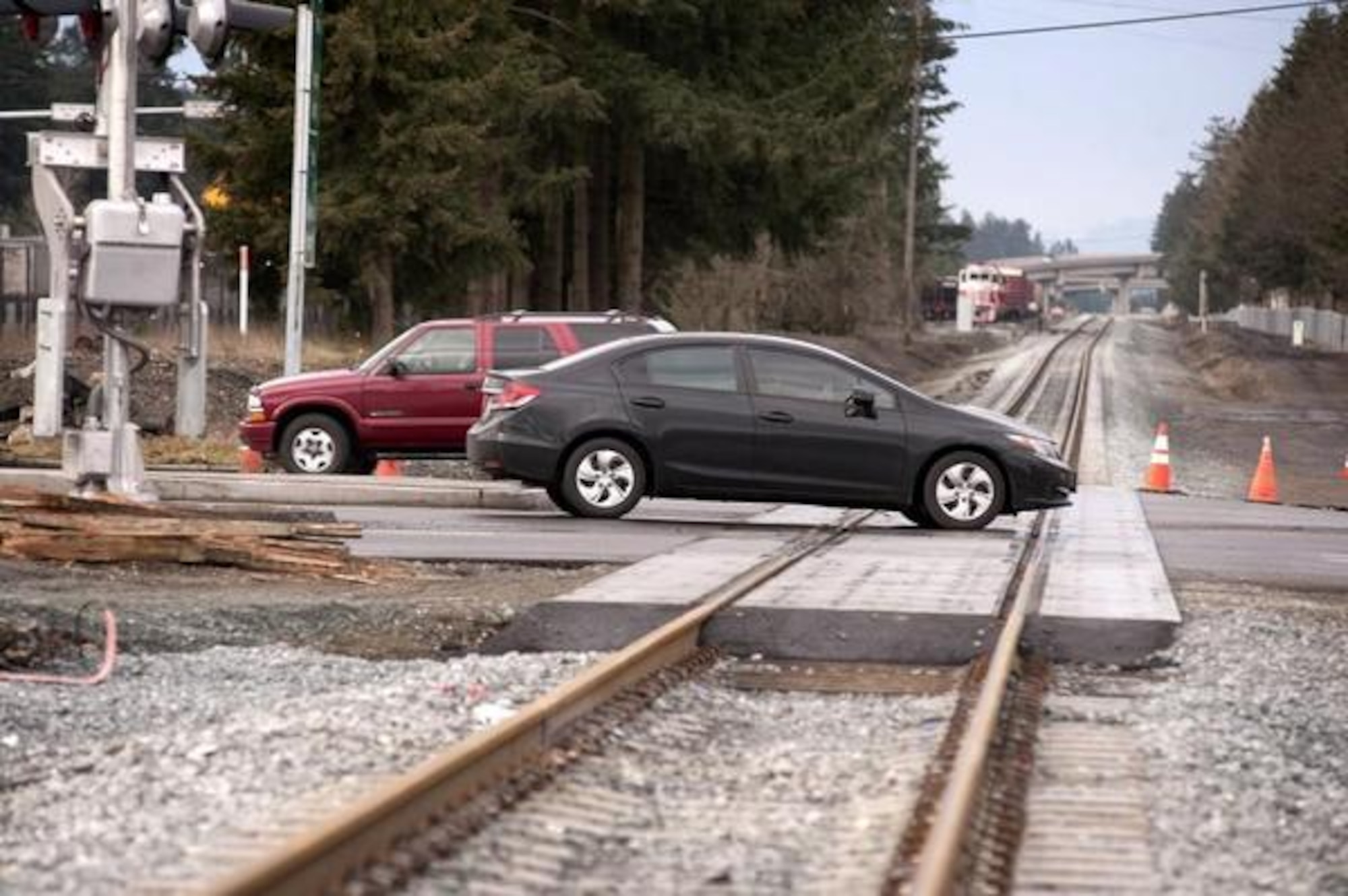 Cars pass over the newly renovated train crossing along Barksdale Avenue near the DuPont Gate.