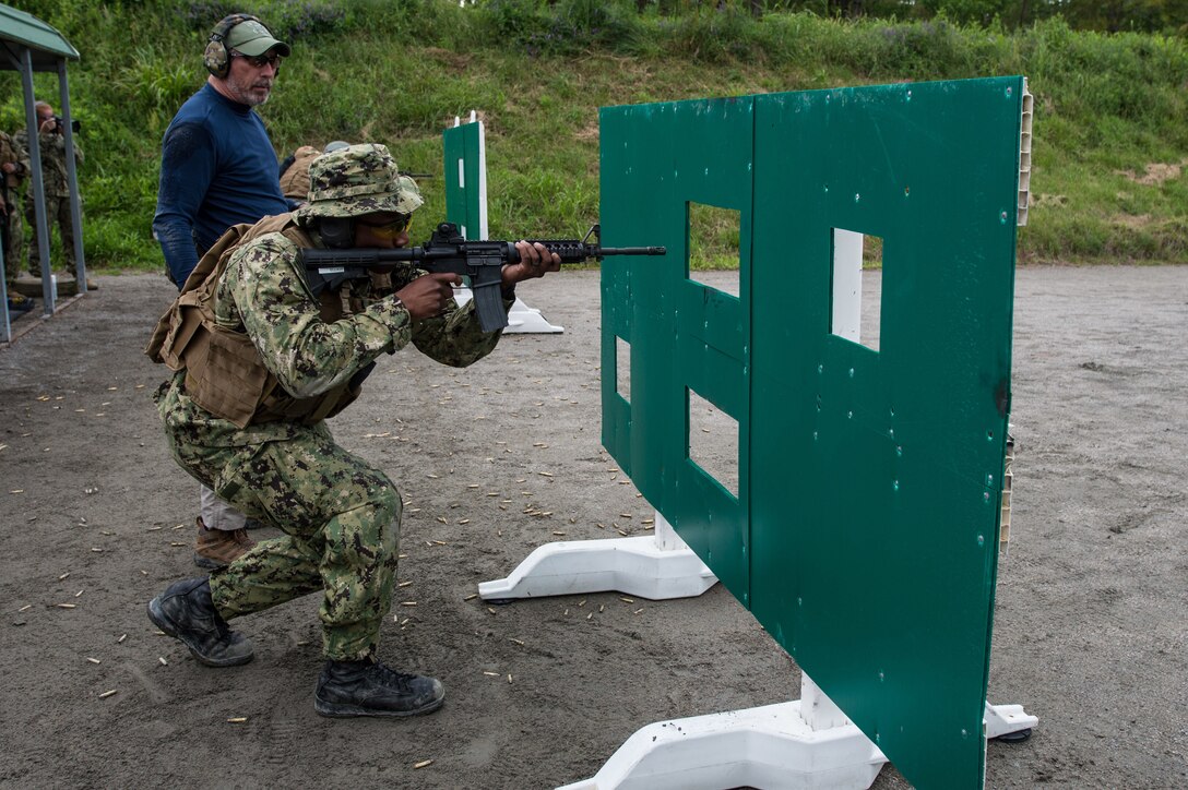 Navy Petty Officer 3rd Class Sean Elliot stands behind a barricade during a weapons qualification exercise in Virginia Beach, Va., May 13, 2017. Elliot is assigned to Pre-Commissioning Unit Gerald R. Ford. Navy photo by Petty Officer 1st Class David Kolmel