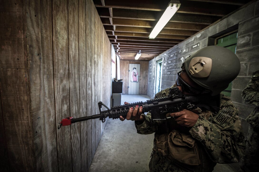 Navy Petty Officer 2nd Class Brittney Cannady clears a hallway as during close quarter battle training in Chesapeake, Va., May 15, 2017. Cannady is assigned to Expeditionary Combat Camera. Navy photo by Petty Officer 2nd Class Ridge Leoni
