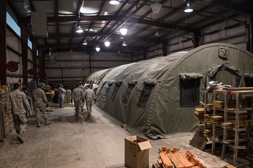 PETERSON AIR FORCE BASE, Colo. – Airmen with the 21st Civil Engineer Squadron set up two tents during a beddown exercise during a monthly training day, May 18, 2017, at Peterson Air Force Base, Colo. Approximately 100 21st CES Airmen came together for the monthly training day, also known as Prime Beef Day, to complete a beddown exercise. The squadron was split up into two groups for the day: logistics planning group and hands-on training. (U.S. Air Force photo by Staff Sgt. Tiffany Lundberg)