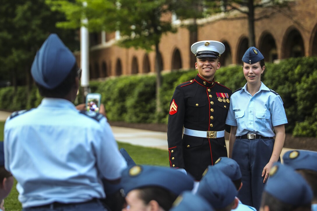 Cpl. Fernando Maldonado, crowd educator with Marine Barracks Washington D.C., takes a photo with a Junior Reserve Officer Training Corps member during a Friday Evening Parade at the Barracks, May 19, 2017. The guest of honor for the parade was Secretary of Homeland Security, John F. Kelly, and the hosting official was Commandant of the Marine Corps Gen. Robert B. Neller. (Official Marine Corps photo by Lance Cpl. Damon Mclean/Released)