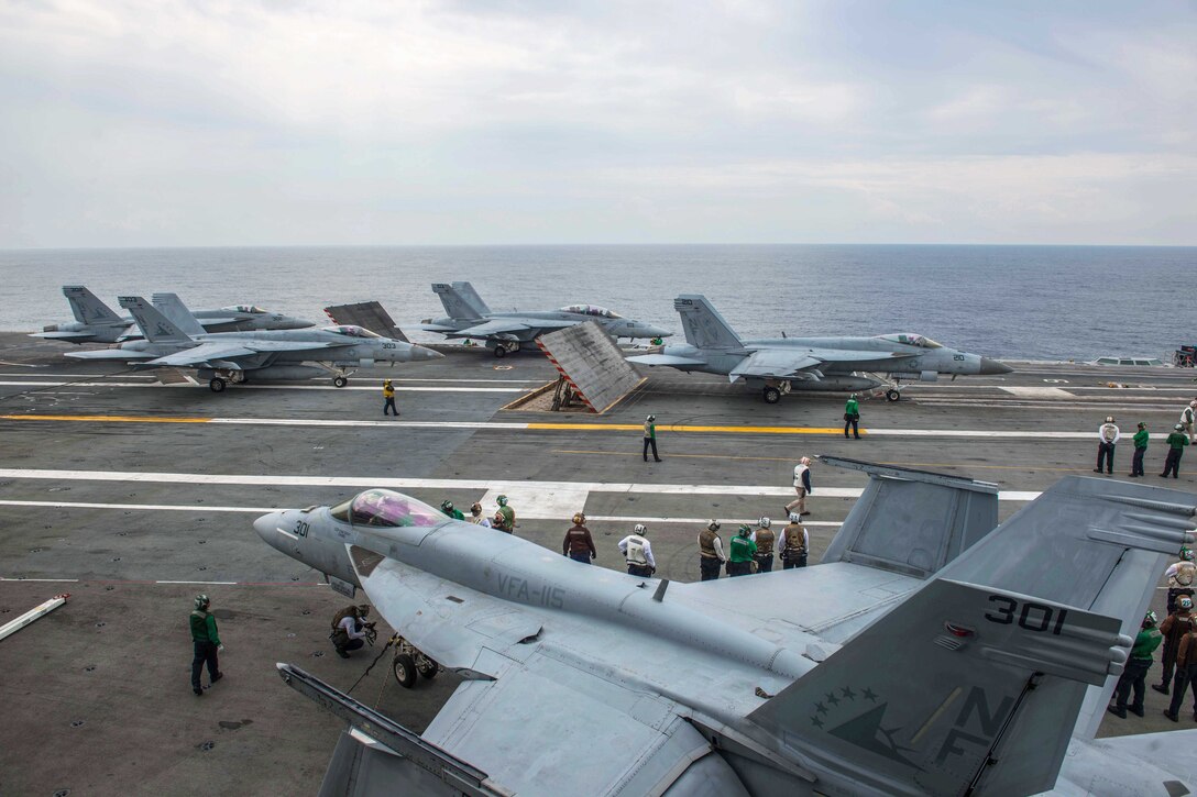 Sailors prepare F/A-18 Super Hornet aircraft before launching aboard the flight deck of the aircraft carrier USS Ronald Reagan in the waters south of Japan, May 18, 2017. Navy photo by Petty Officer 2nd Class Jamal McNeill