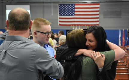 A proud future U.S. Army Reserve mom hugs her daughter, Calista Lage, after she received an "Our Community Salutes" certificate from Medal of Honor recipient Command Sergeant Major (Ret.) Kenneth E. Stumpf and Fort McCoy Senior Commander and 88th Regional Support Command Commanding General, Maj. Gen. Patrick Reinert during an “Our Community Salutes” event at Fort McCoy, Wisconsin on Armed Forces Day, May 20, to recognize and honor graduating high school seniors who have committed to enlist in the Armed Forces following high school graduation.