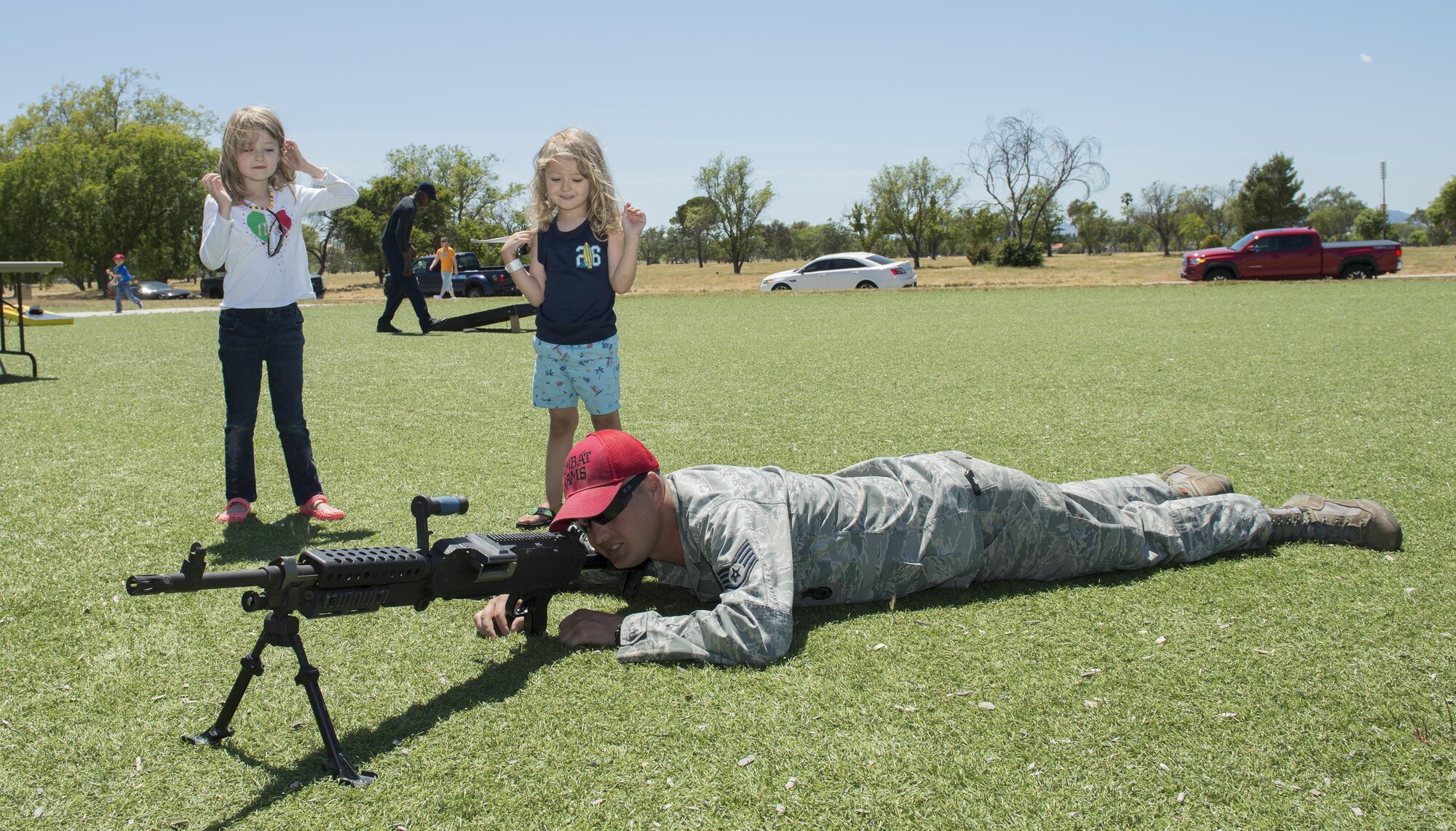 Staff Sgt. Christopher Rainwater, 60th Security Forces Squadron, demonstrates how to line up the shot during the National Police Week Picnic May 17, 2017 at Travis Air Force Base, Calif.  Established by a joint resolution of Congress in 1962, National Police Week pays special recognition to law enforcement officers who have lost their lives in the line of duty for the safety and protection of others. Police Week gives the 60th SFS an opportunity to inform, educate and strengthen Travis community relations. (U.S. Air Force photo/ Heide Couch)