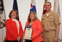 Denise Abraham (center), head of NUWC Division Newport's Contracting Department, receives the 2016 Commanding Officer/Technical Director Award during a ceremony on May 18. The award was presented by Mary Wohlgemuth, SES, NUWC Newport's technical director and Capt. Michael Coughlin, NUWC Newport's commanding officer.

