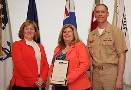 Denise Abraham (center), head of NUWC Division Newport's Contracting Department, receives the 2016 Commanding Officer/Technical Director Award during a ceremony on May 18. The award was presented by Mary Wohlgemuth, SES, NUWC Newport's technical director and Capt. Michael Coughlin, NUWC Newport's commanding officer.

