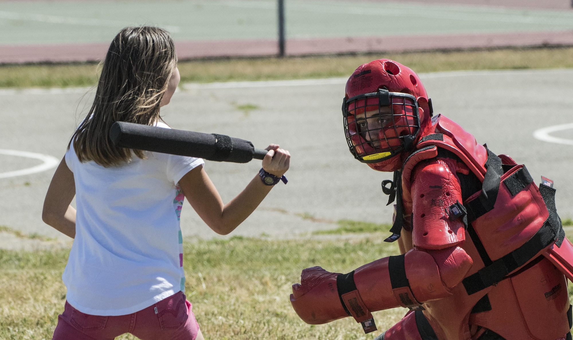 Children had the opportunity to try and take down a 60th Security Forces Squadron defender wearing the Red-Man suit used for defensive tactics training during the National Police Week Picnic, May 17, 2017 at Travis Air Force Base, Calif. Established by a joint resolution of Congress in 1962, National Police Week pays special recognition to law enforcement officers who have lost their lives in the line of duty for the safety and protection of others. Police Week gives the 60th SFS an opportunity to inform, educate and strengthen Travis community relations. (U.S. Air Force photo/ Heide Couch)