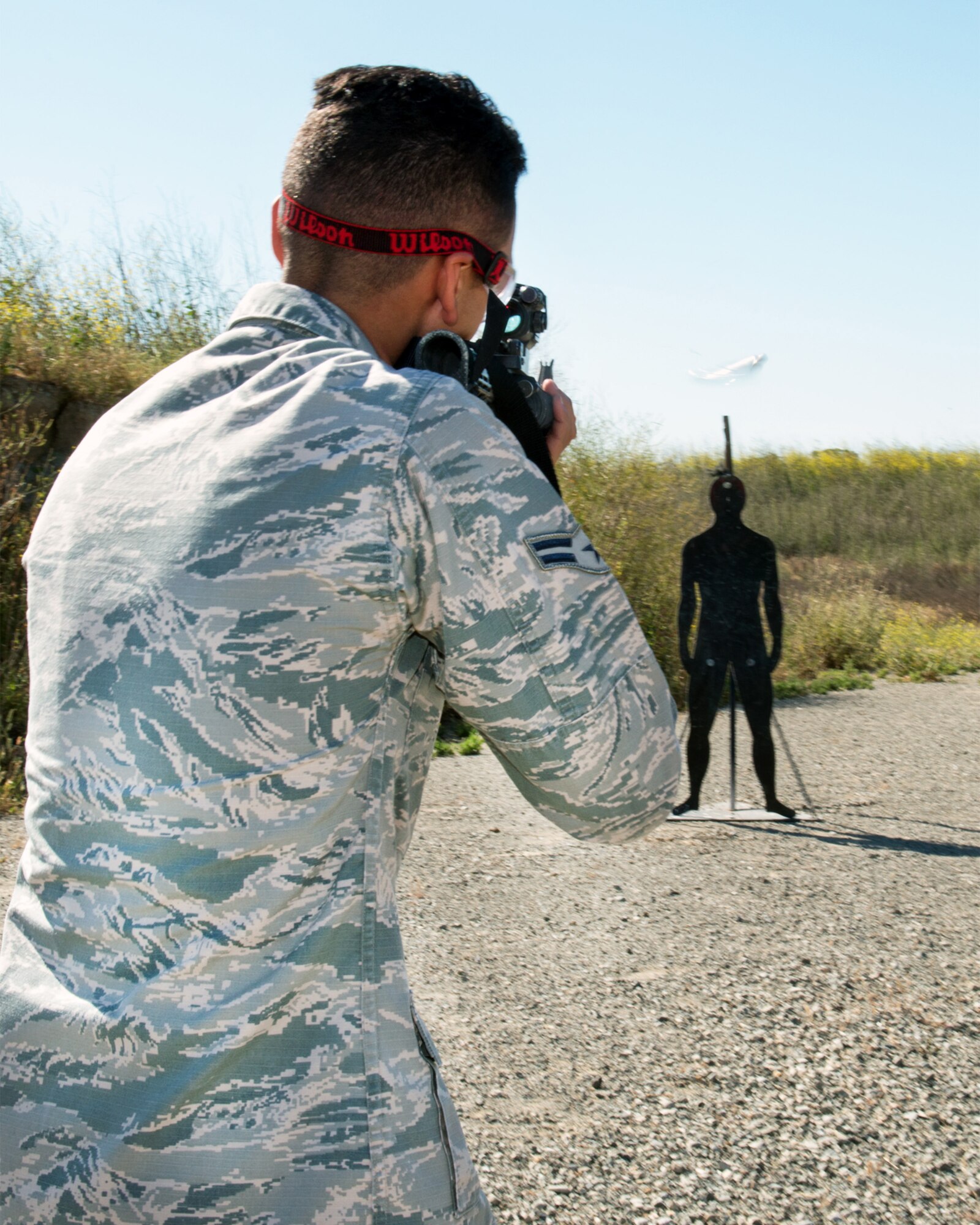 U.S. Air Force Airman 1st Class Joshua Adolf, 60th Security Forces Squadron, Travis Air Force Base, Calif., competes in a shooting competition May 18, 2017. The competition was one of several events sponsored by the squadron in honor of Police Week. (U.S. Air Force photo by Louis Briscese)