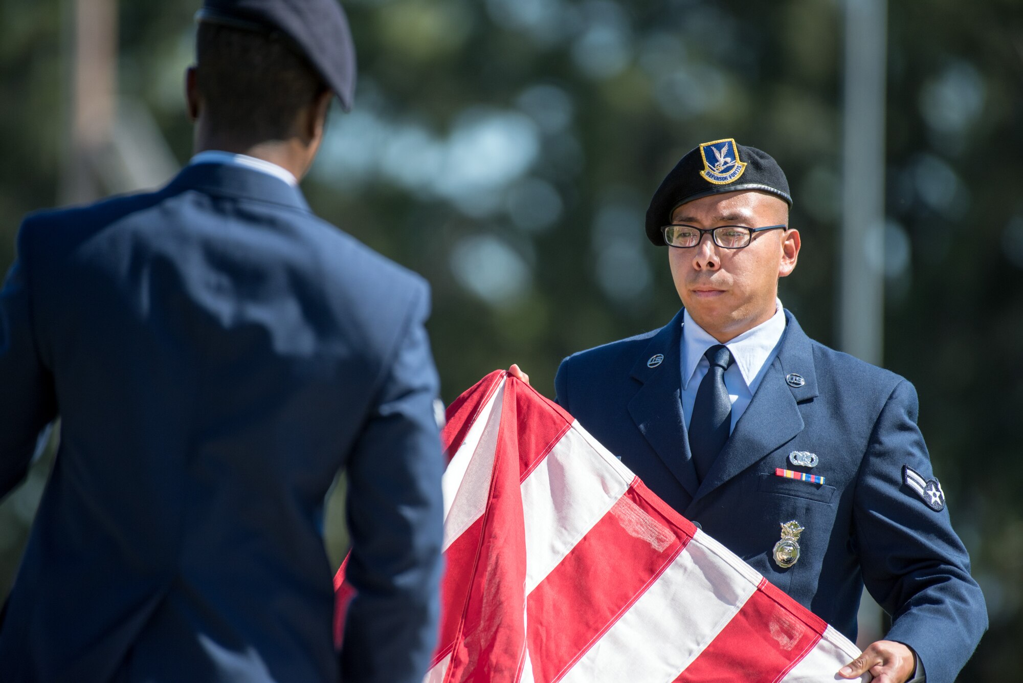 Defenders from the 60th Security Forces Squadron, Travis Air Force Base, Calif., perform a retreat ceremony May 18, 2017. The ceremony was one of several events sponsored by the squadron in honor of Police Week. (U.S. Air Force photo by Louis Briscese)