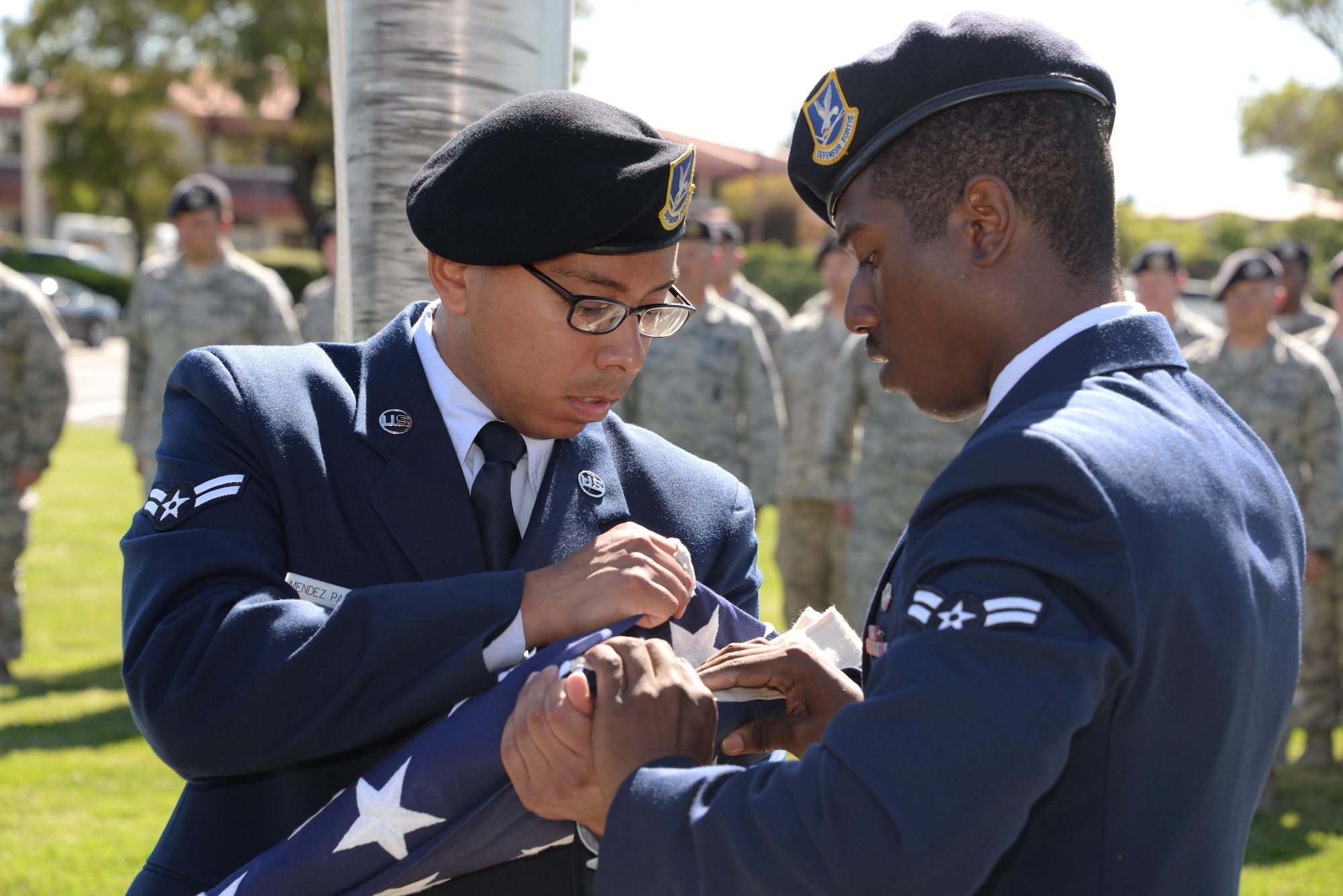 Airmen assigned to the 60th Security Forces Squadron at Travis Air Force Base, Calif., fold the American flag during a retreat ceremony at the base May 18, 2017, to close Police Week. The event featured a formation of security forces Airmen and the reading of the names of fallen defenders. (U.S. Air Force photo/Tech. Sgt. James Hodgman)