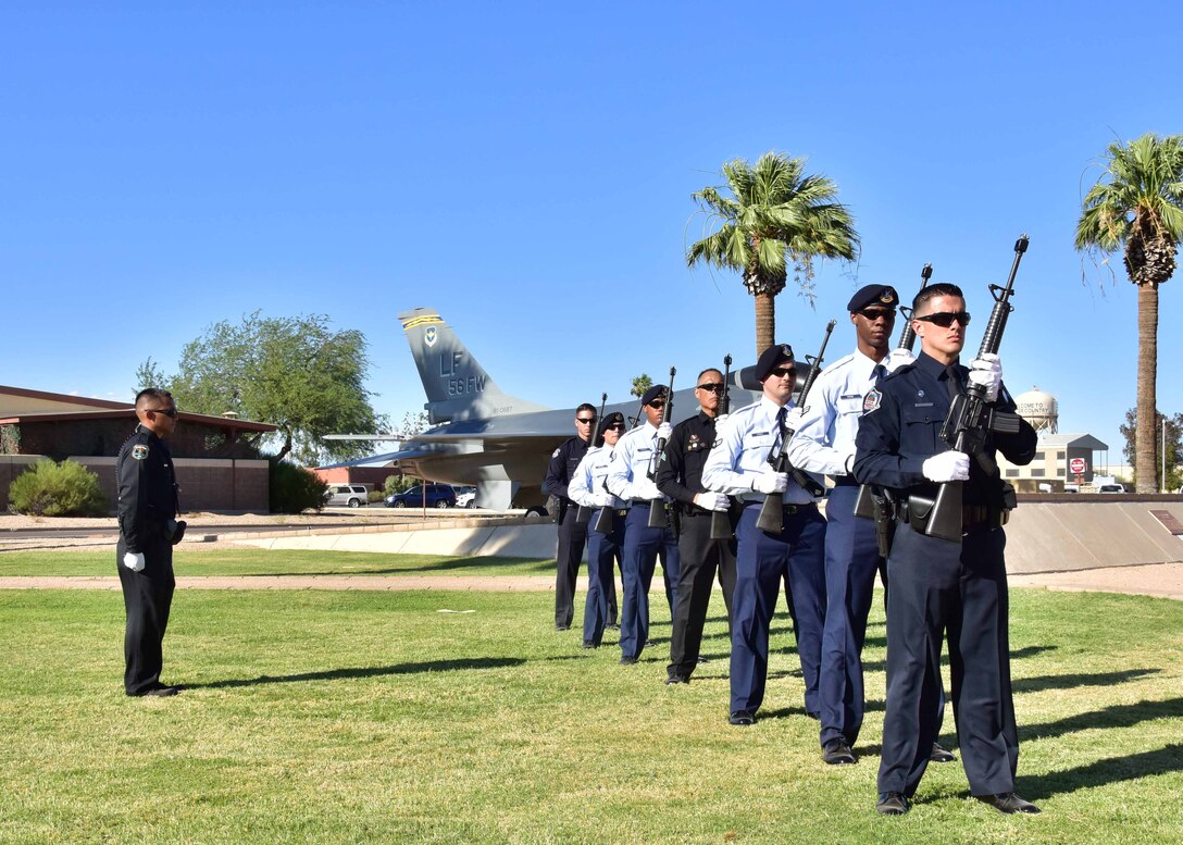 Citizen Airmen from the 944th Fighter Wing in their local police department uniforms along with defenders from the 56th Fighter Wing perform a 21-gun salute during the S.S. Mayaguez retreat ceremony May 18 at Luke Air Force Base, Ariz. (U.S. Air Force photo by Tech. Sgt. Louis Vega Jr.)