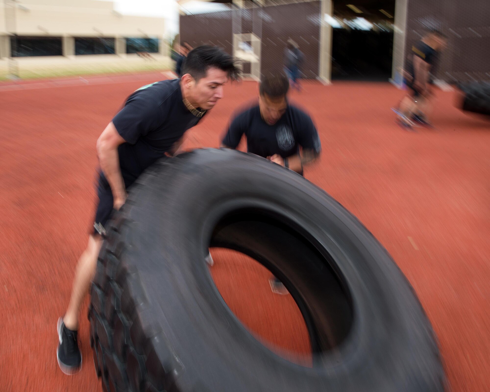 Defenders from the 60th Security Forces Squadron lift tires during the Defender’s Challenge at Travis Air Force Base, Calif., May 16, 2017. The competition is just one of several events being sponsored by the squadron in honor of Police Week. (U.S. Air Force photo by Louis Briscese)