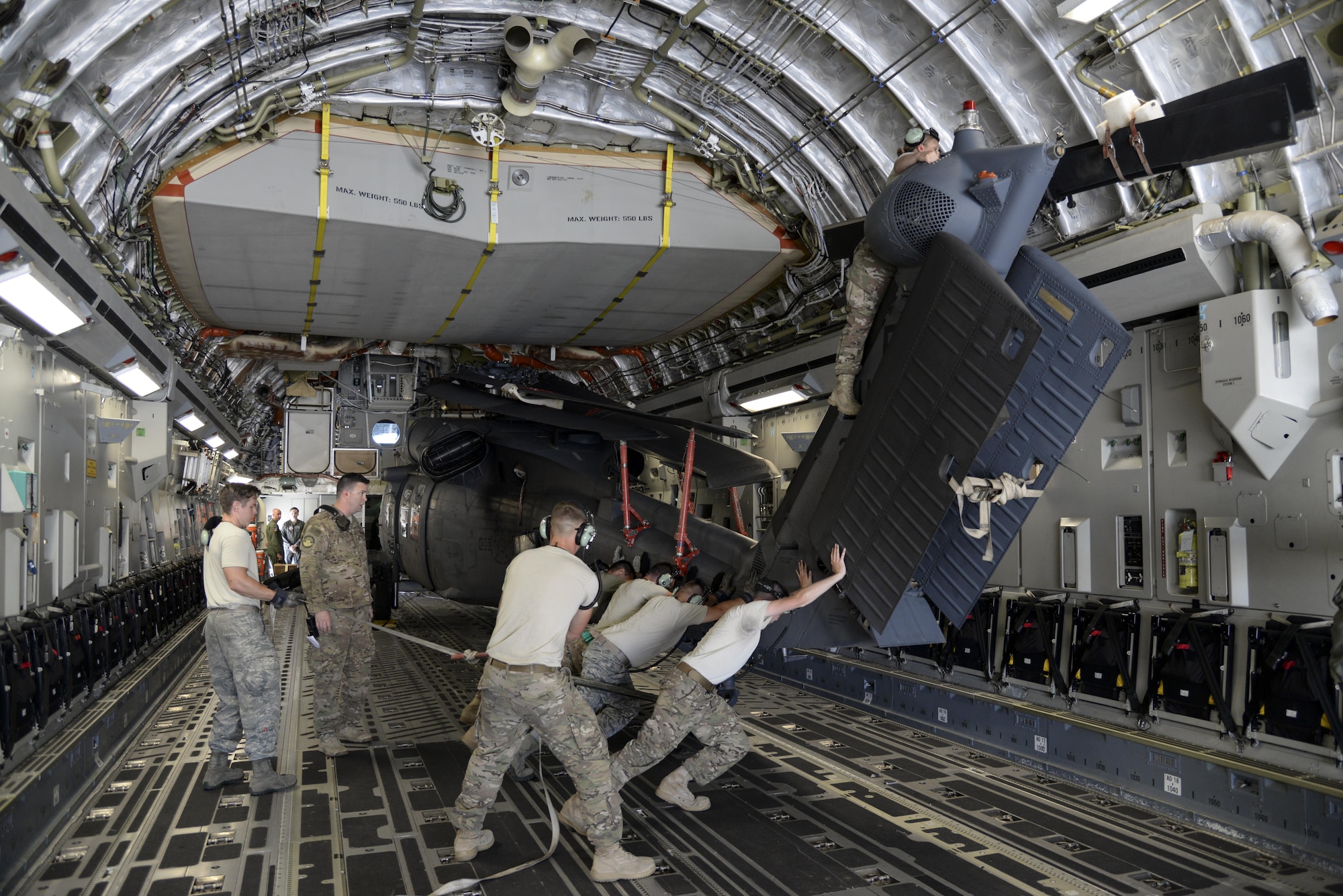 Members of the 723d Aircraft Maintenance Squadron, 41st Helicopter Maintenance Unit assigned to Moody Air Force Base, Ga., position an HH-60G Pave Hawk search and rescue helicopter May 15, 2017, on a 3d Airlift Squadron C-17 Globemaster III at Moody AFB. The maintainers loaded two HH-60 aircraft, which were flown to Langley Air Force Base, Va., for Exercise Rapid Rescue on May 17. (U.S. Air Force Photo by Senior Airman Aaron J. Jenne)