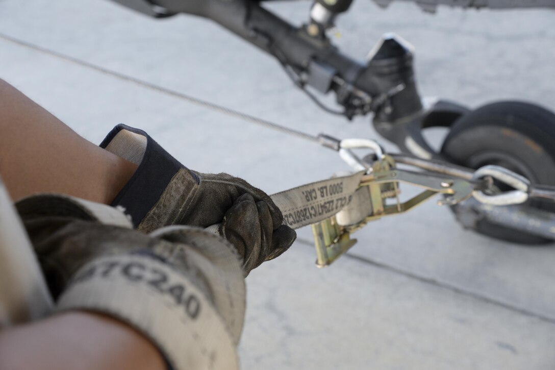 A member of the 723d Aircraft Maintenance Squadron, 41st Helicopter Maintenance Unit assigned to Moody Air Force Base, Ga., guides an HH-60G Pave Hawk search and rescue helicopter May 15, 2017, at Moody AFB. The helicopter was loaded onto a 3d Airlift Squadron C-17 Globemaster III to be flown to Langley AFB, Va., to be used during Exercise RAPID RESCUE May 17. (U.S. photo by Senior Airman Aaron J. Jenne)