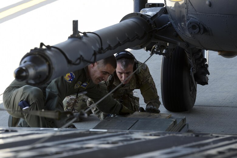 Tech. Sgt. Brendan Proctor, 3d Airlift Squadron loadmaster, and Staff Sgt. Sean O’Neill, 723d Aircraft Maintenance Squadron, 41st Helicopter Maintenance Unit crew chief assigned to Moody Air Force Base, Ga., ensure proper block placement prior to loading an HH-60G Pave Hawk search and rescue helicopter onto a 3d AS C-17 Globemaster III May 15, 2017, at Moody AFB. Special care was taken to not damage either aircraft when loading. (U.S. Air Force photo by Senior Airman Aaron J. Jenne)