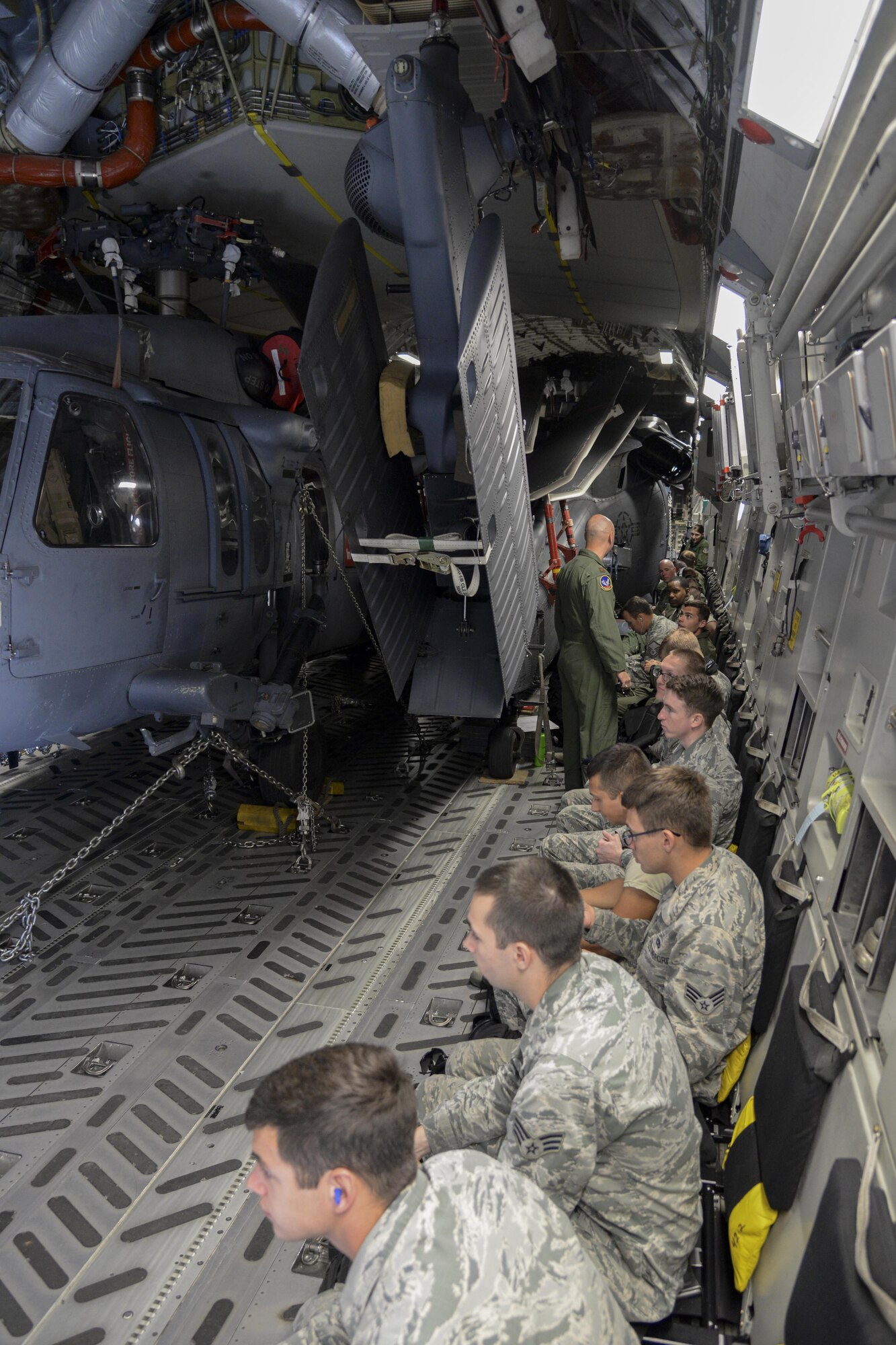 Members of the 38th Rescue Squadron and 723d Aircraft Maintenance Squadron, 41st Helicopter Maintenance Unit, both from Moody Air Force Base, Ga., prepare for takeoff May 15, 2017, aboard a 3d Airlift Squadron C-17 at Moody AFB, Ga. Two HH-60G Pave Hawk search and rescue helicopters and 40 members assigned to Moody AFB flew to Langley AFB, Va., to participate in Exercise RAPID RESCUE May 17. (U.S. Air Force photo by Senior Airman Aaron J. Jenne)