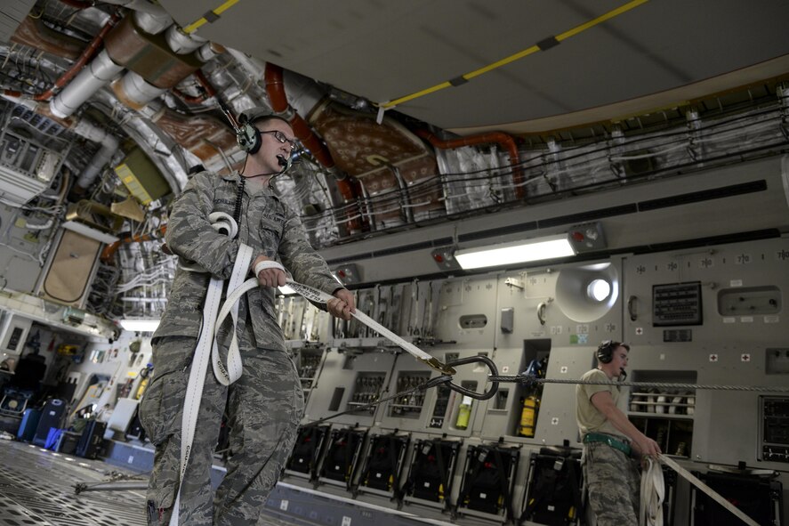 Airman 1st Class Isaac Schuler, 723d Aircraft Maintenance Squadron, 41st Helicopter Maintenance Unit electronic warfare technician assigned to Moody Air Force Base, Ga., guides an HH-60G Pave Hawk search and rescue helicopter May 16, 2017, as it is offloaded from a 3d Airlift Squadron C-17 Globemaster III at Langley Air Force Base, Va. The Airmen worked in unison to ensure the helicopter was safely off-loaded. (U.S. Air Force photo by Senior Airman Aaron J. Jenne)