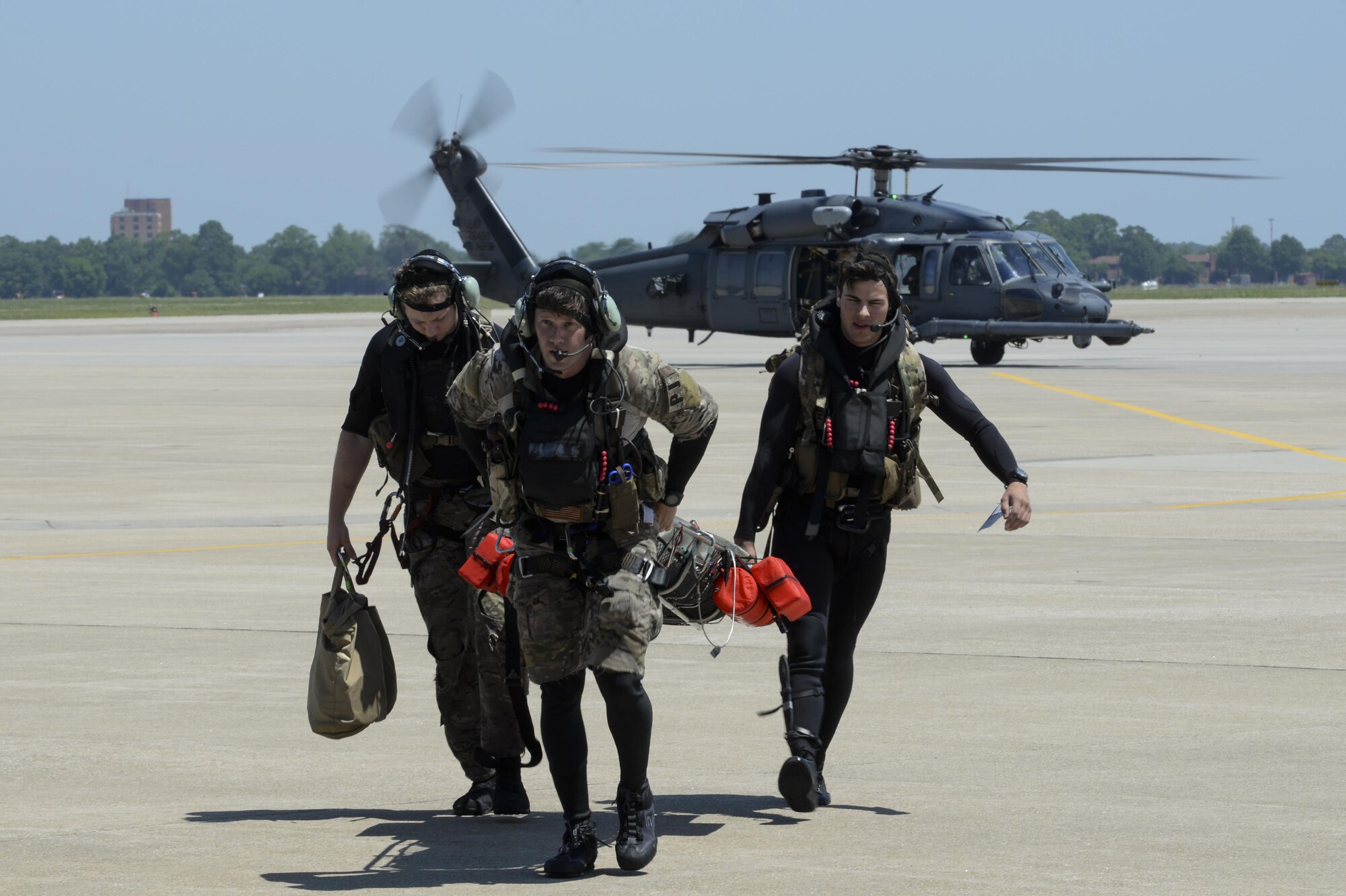 From left, Staff Sgt. Robert Hall, Staff Sgt. Travis Lester, and Senior Airman Eddie Judge, 38th Rescue Squadron pararescuemen assigned to Moody Air Force Base, Ga., carry an Airman with simulated injuries toward a 3d Airlift Squadron C-17 Globemaster III May 17, 2017, during Exercise RAPID RESCUE at Langley AFB, Va. The C-17 was prepped and ready to takeoff for a simulated aeromedical evacuation flight when the search and rescue team arrived. (U.S. Air Force photo by Senior Airman Aaron J. Jenne)