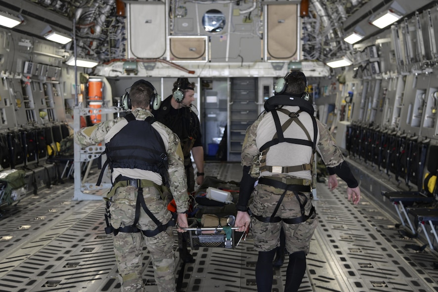 Members of the 38th Rescue Squadron assigned to Moody Air Force Base, Ga., carry an Airman with simulated injuries May 17, 2017, aboard a 3d Airlift Squadron C-17 Globemaster III during Exercise RAPID RESCUE. A few minutes later, the aircraft departed from Langley AFB, Va., simulating an aeromedical evacuation for three injured Airmen. (U.S. Air Force photo by Senior Airman Aaron J. Jenne)