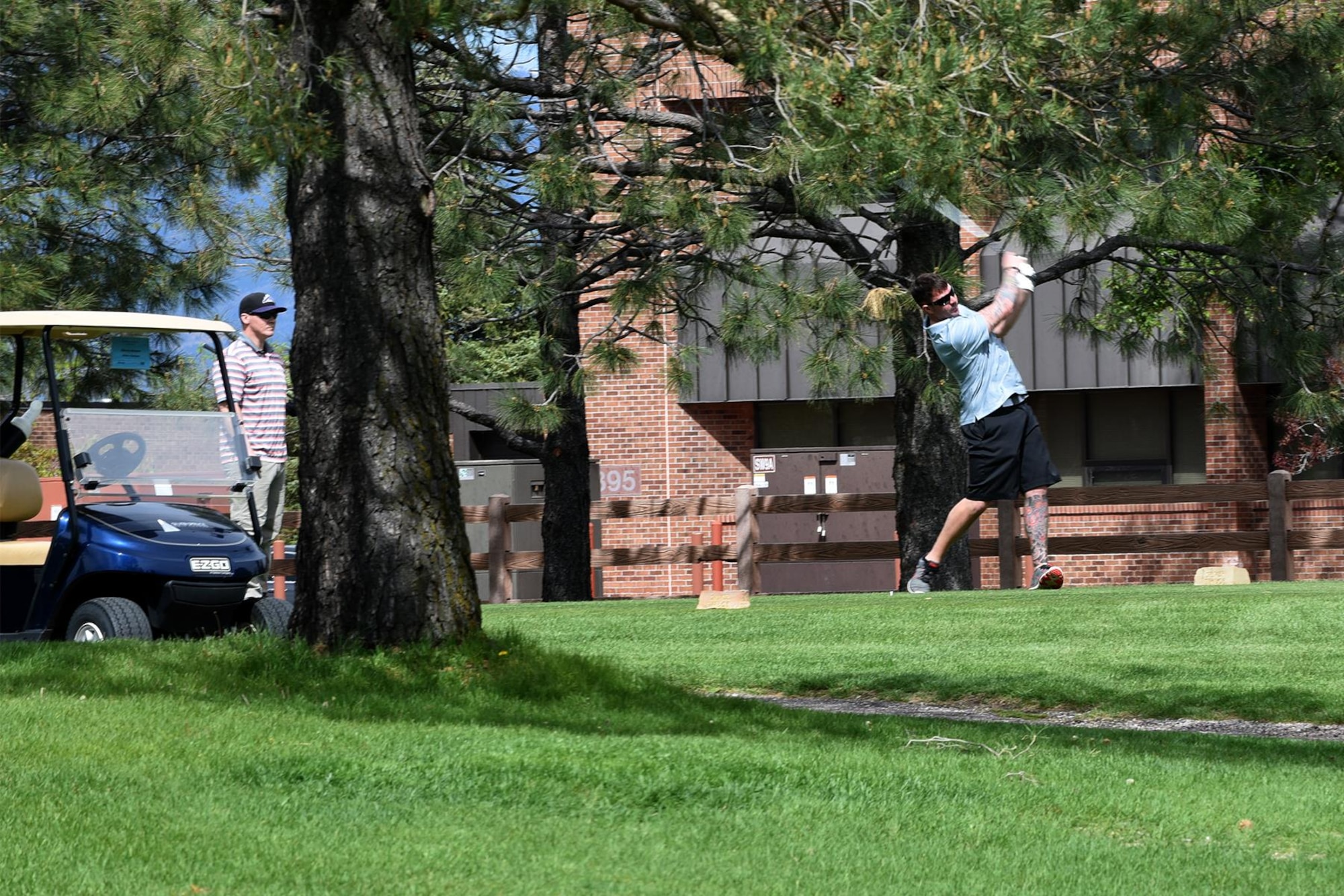 PETERSON AIR FORCE BASE, Colo. – Airmen from the 21st Security Forces Squadron and 21st Civil Engineer Squadron, tee off at the 18th tee box during the National Police Week golf tournament at Silver Spruce golf course, May 17, 2017, Peterson Air Force Base, Colo. Established in 1962 as a joint resolution in Congress, National Police Week recognizes law enforcement officers who have lost their lives in the line of duty. (U.S. Air Force photo by Robb Lingley)
