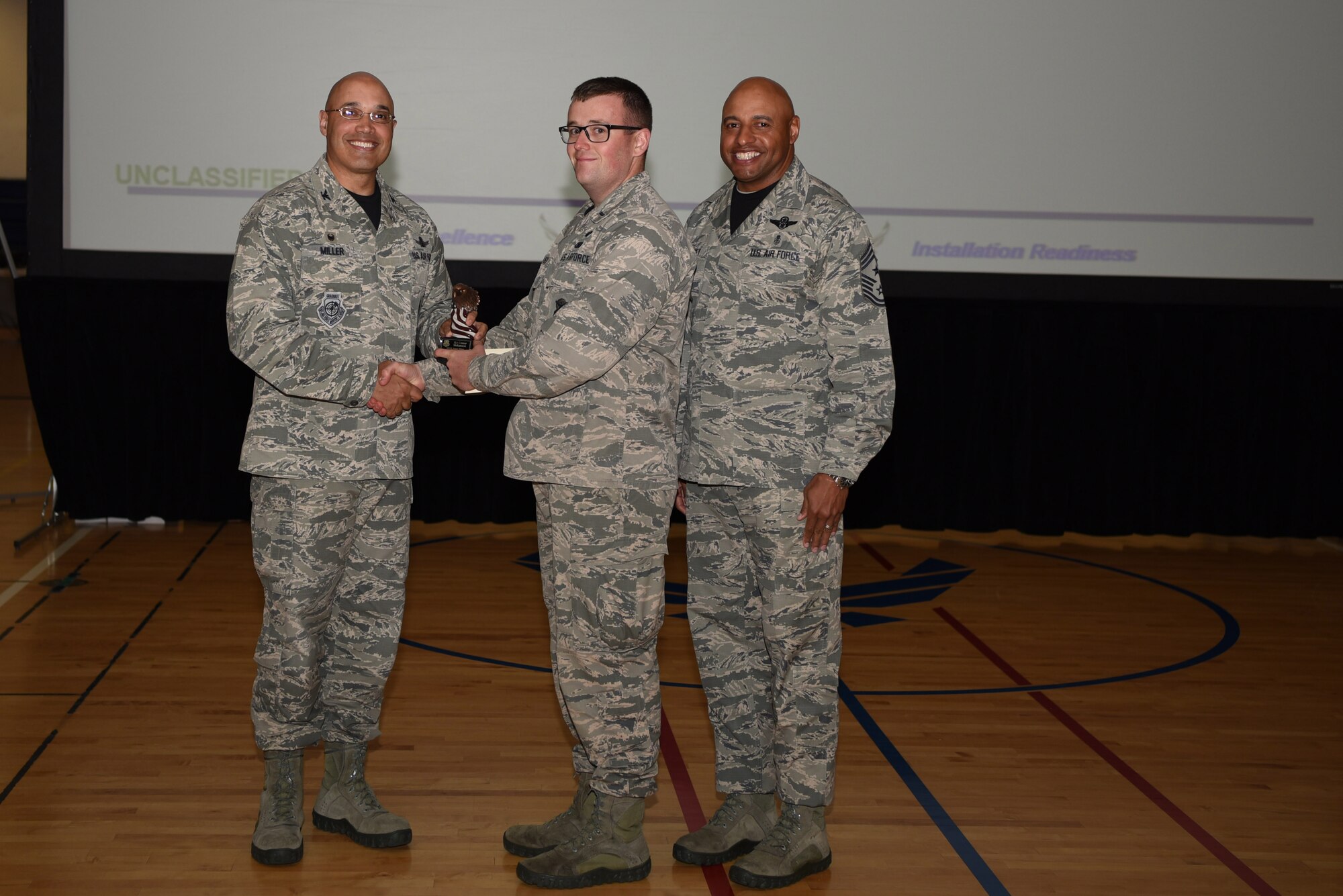 1st Lt. Conor Melanson, 460th Security Forces Squadron operations officer, receives the Company Grade Officer of the Quarter Award May 19, 2017, on Buckley Air Force Base, Colo.  Awards were given to the Team Buckley members who showed dedication, hard work and exceeded their supervisor’s expectations. (U.S. Air Force photo by Airman 1st Class Holden S. Faul/ released)