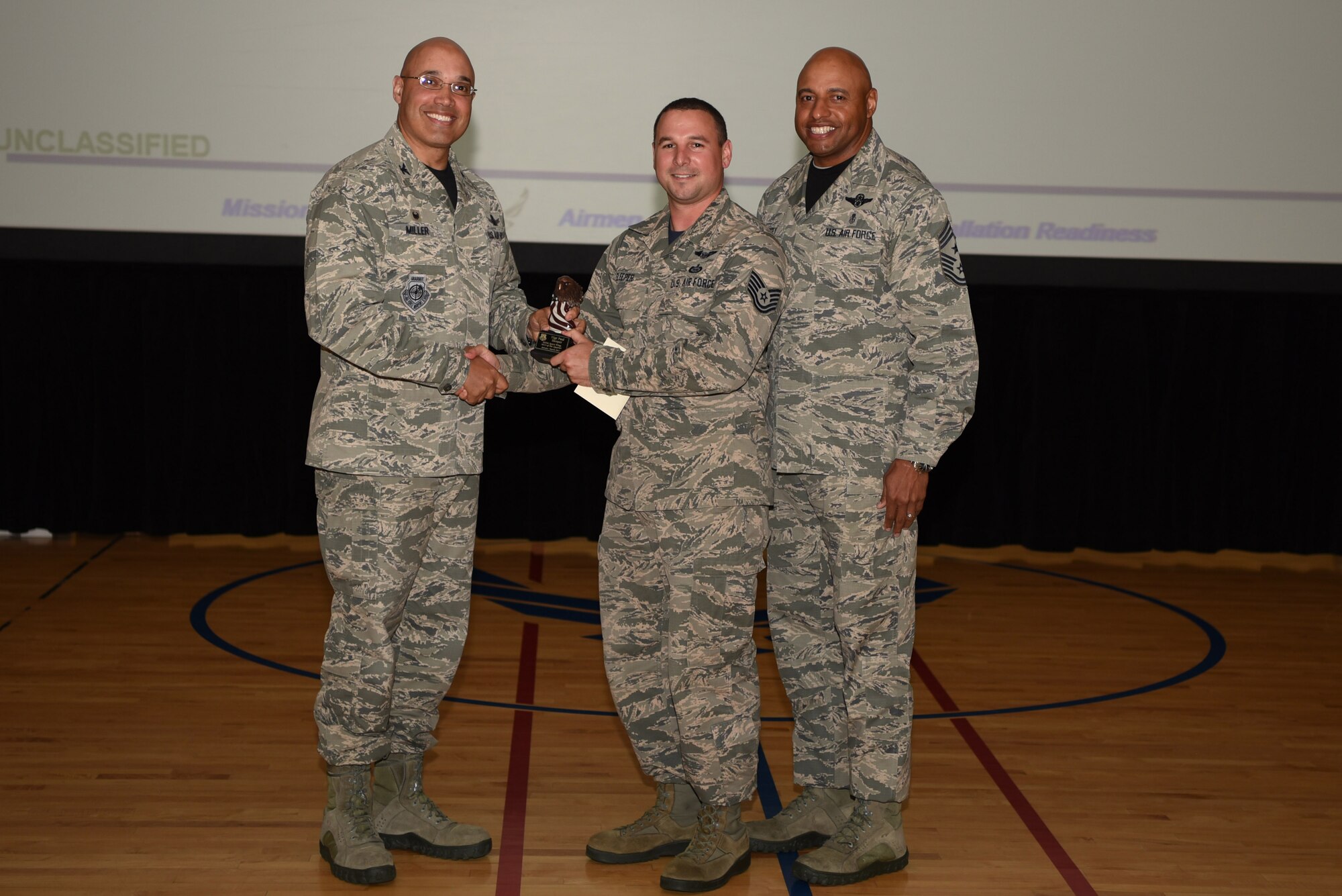 Paul Sleeper, 460th Operations Group, receives the Noncommissioned Officer of the Quarter Award May 19, 2017, on Buckley Air Force Base, Colo.  Awards were given to the Team Buckley members who showed dedication, hard work and exceeded their supervisor’s expectations. (U.S. Air Force photo by Airman 1st Class Holden S. Faul/ released)