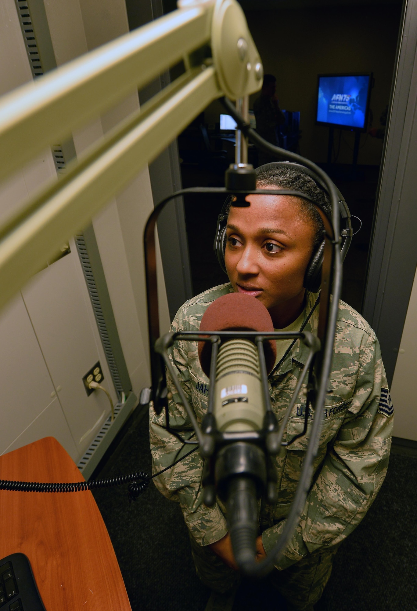 U.S. Air Force Tech. Sgt. Jamila Jahic, American Forces Network Weather Center NCO in charge, records the day’s global-forecasts in a sound booth at the 557th Weather Wing headquarters March 31, Offutt Air Force Base, Neb.  Jahic leads five Airmen that are tasked with providing 1,000 pieces of weather data to 400,000 members of the Department of Defense and Department of State stationed around the globe. (U.S. Air Force photo by Josh Plueger)