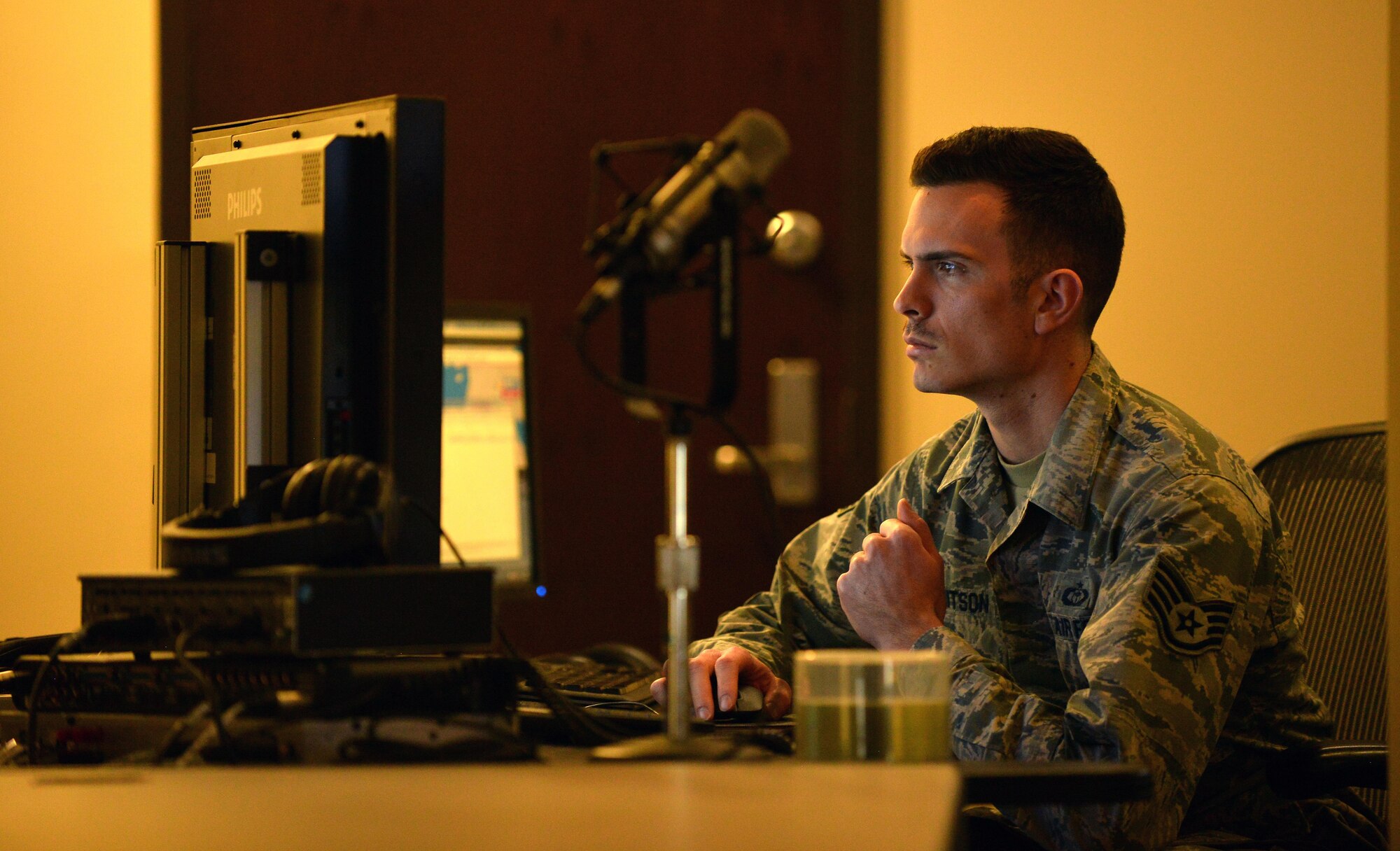 U.S Air Force Staff Sgt. Ryan Whitson, American Forces Network Weather Center forecaster, reviews weather data at the 557th Weather Wing headquarters March 31, Offutt Air Force Base, Neb.  The five Airmen team assigned the AFN Weather Center are the sole forecasters in charge of recording daily weather broadcasts for the internet, prints and television shows worldwide. (U.S. Air Force photo by Josh Plueger)