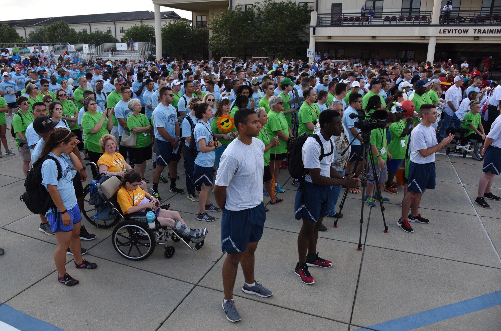 Airmen sponsors and athletes gather at the Levitow Training Support Facility drill pad during the Special Olympics Mississippi 2017 Summer Games opening ceremonies May 19, 2017, on Keesler Air Force Base, Miss. Founded in 1968, Special Olympics hosts sporting events around the world for people of all ages with special needs to include more than 700 athletes from Mississippi. (U.S. Air Force photo by Kemberly Groue)