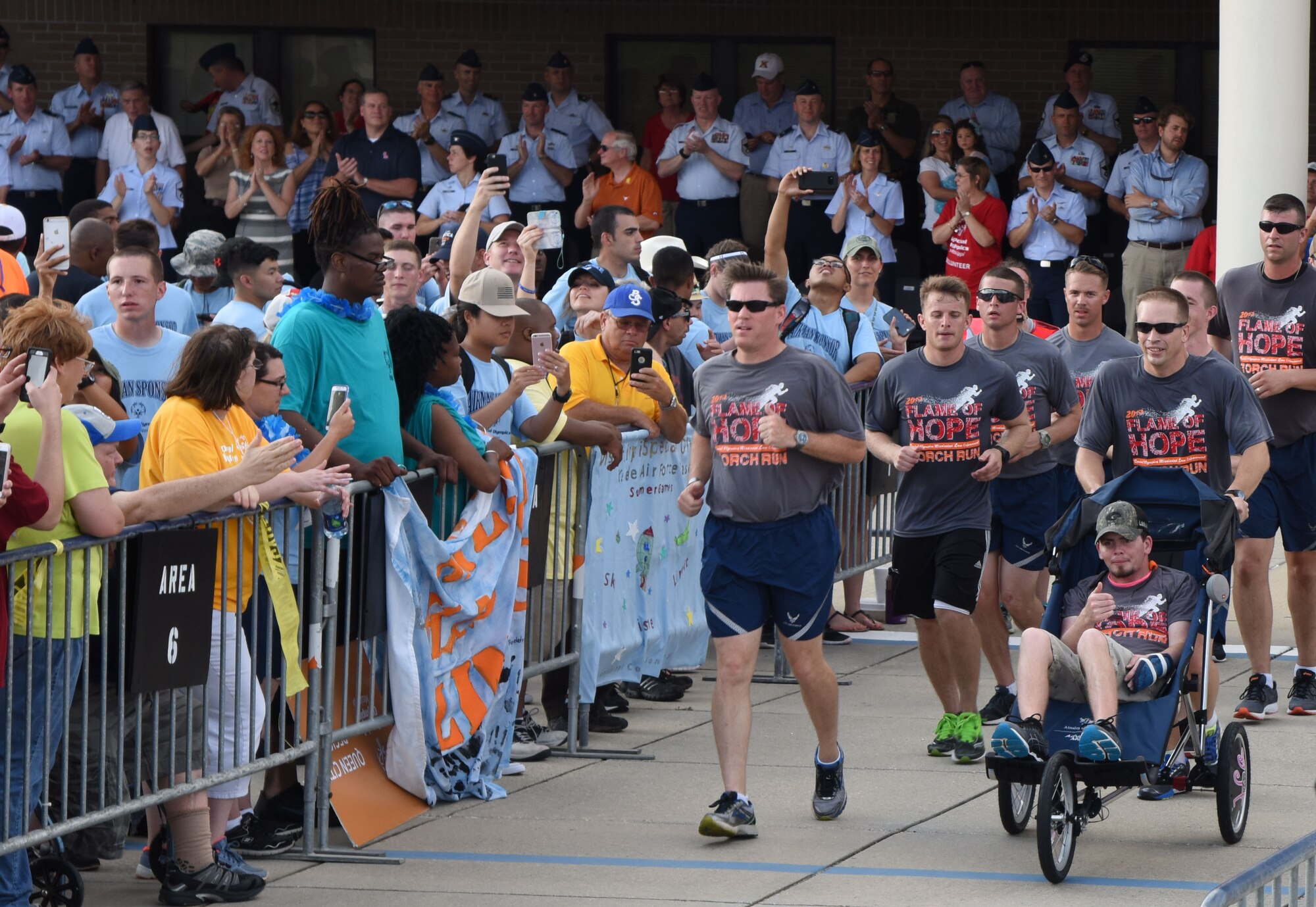 Col. C. Mike Smith, 81st Training Wing vice commander, leads members of the 81st Security Forces Squadron onto the parade field at the Levitow Training Support Facility drill pad during the Special Olympics Mississippi 2017 Summer Games opening ceremonies May 19, 2017, on Keesler Air Force Base, Miss. Founded in 1968, Special Olympics hosts sporting events around the world for people of all ages with special needs to include more than 700 athletes from Mississippi. (U.S. Air Force photo by Kemberly Groue)