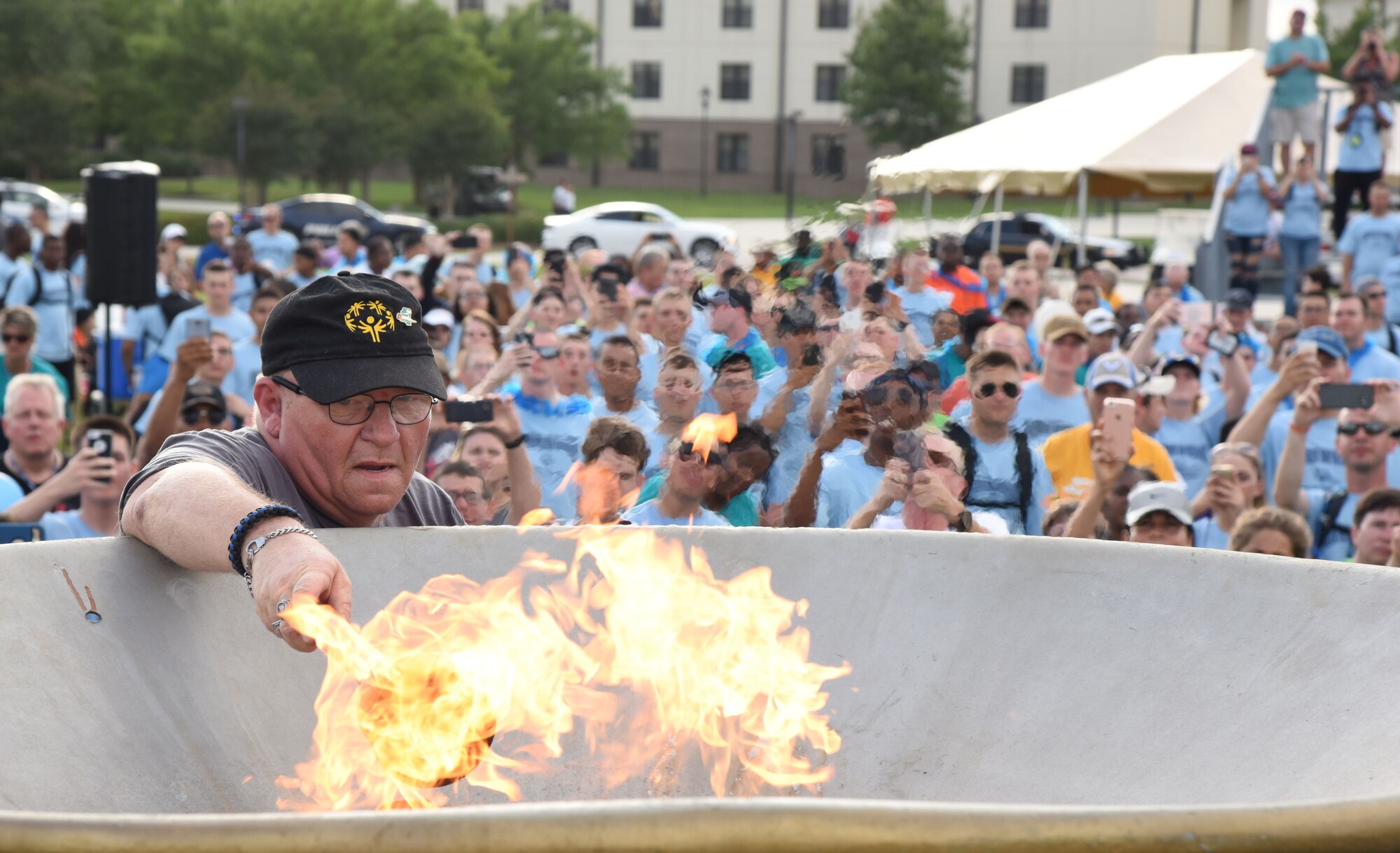 Craig Foshee, Area 1 athlete, lights the torch to open the games during the Special Olympics Mississippi 2017 Summer Games opening ceremonies at the Levitow Training Support Facility drill pad May 19, 2017, on Keesler Air Force Base, Miss. Founded in 1968, Special Olympics hosts sporting events around the world for people of all ages with special needs to include more than 700 athletes from Mississippi. (U.S. Air Force photo by Kemberly Groue)