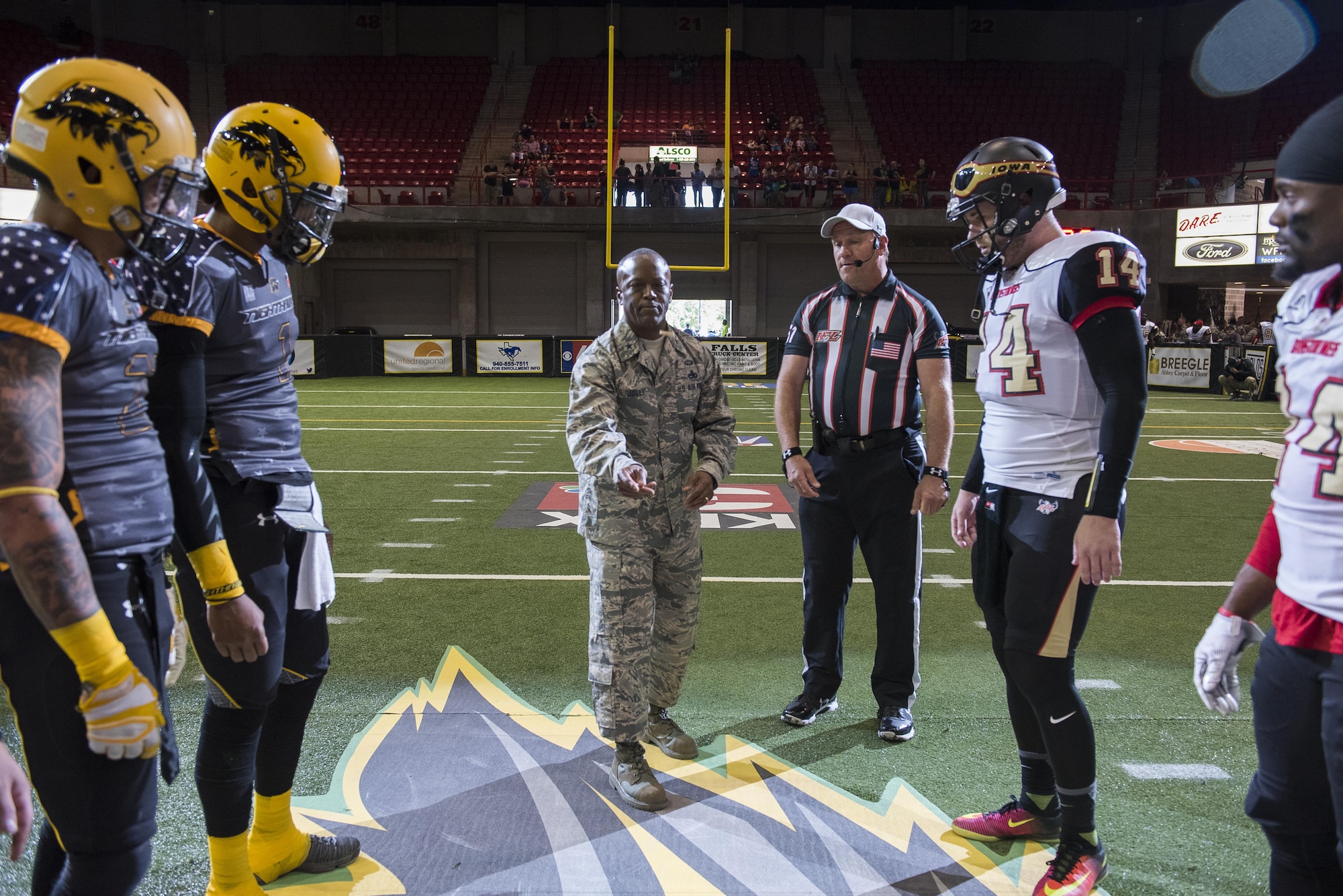 Brig. Gen. Ronald Jolly Sr., 82nd Training Wing commander, tosses the game coin for the Nighthawks military appreciation game who played against the Iowa Barnstormers at the Kay Yeager Coliseum in downtown Wichita Falls, Texas, May 20, 2017. The Nighthawks won the coin toss and started the game. (U.S. Air Force photo by Staff Sgt. Kyle E. Gese)