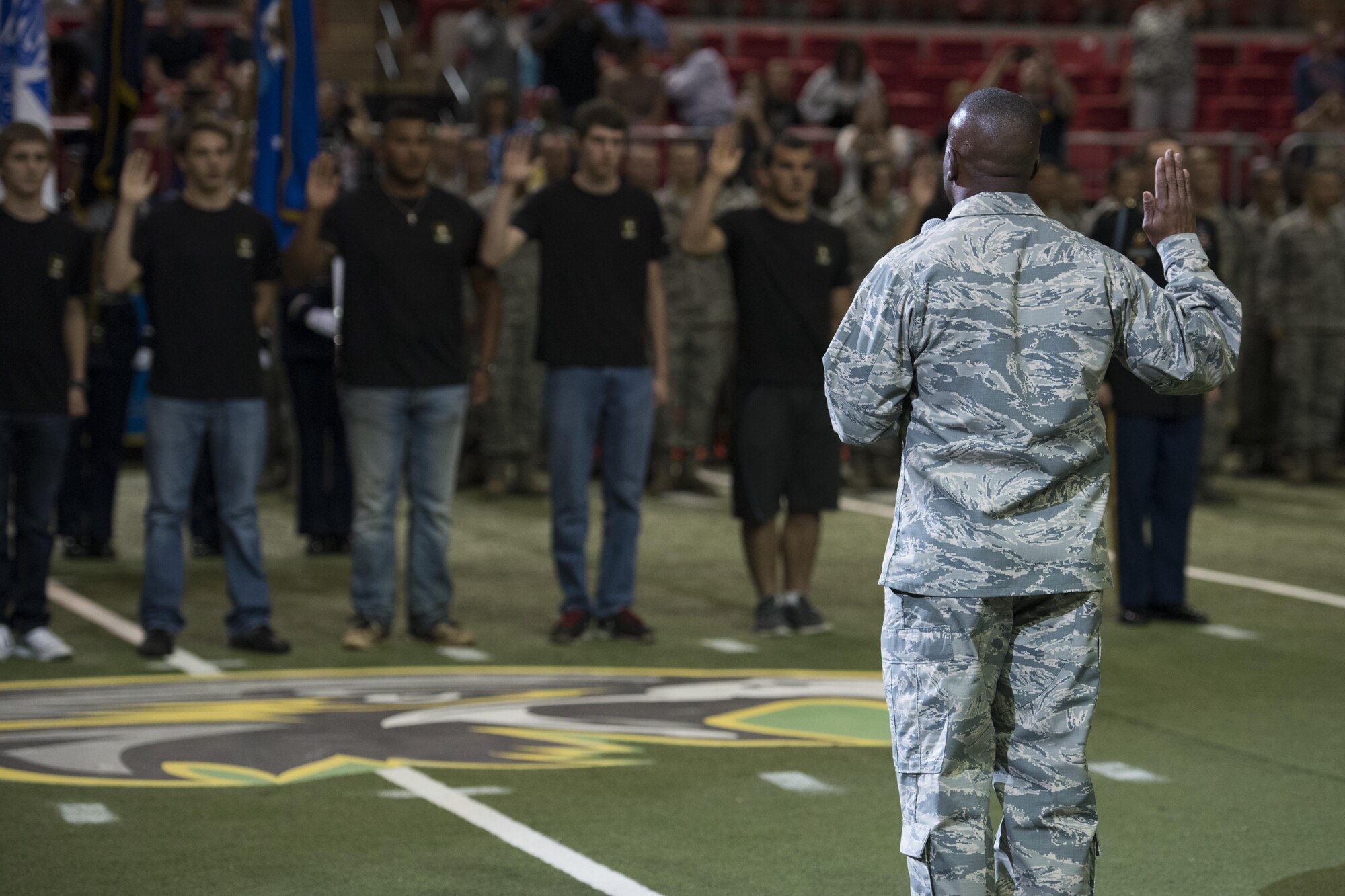 Brig. Gen. Ronald Jolly Sr., 82nd Training Wing commander, administers the oath of enlistment to future Airmen, Soldiers and Sailors during the Nighthawks military appreciation football game at the Kay Yeager Coliseum in downtown Wichita Falls, Texas, May 20, 2017. There were three U.S. Navy, six U.S. Army and three U.S. Air Force enlistees who took the oath during half-time. (U.S. Air Force photo by Staff Sgt. Kyle E. Gese)