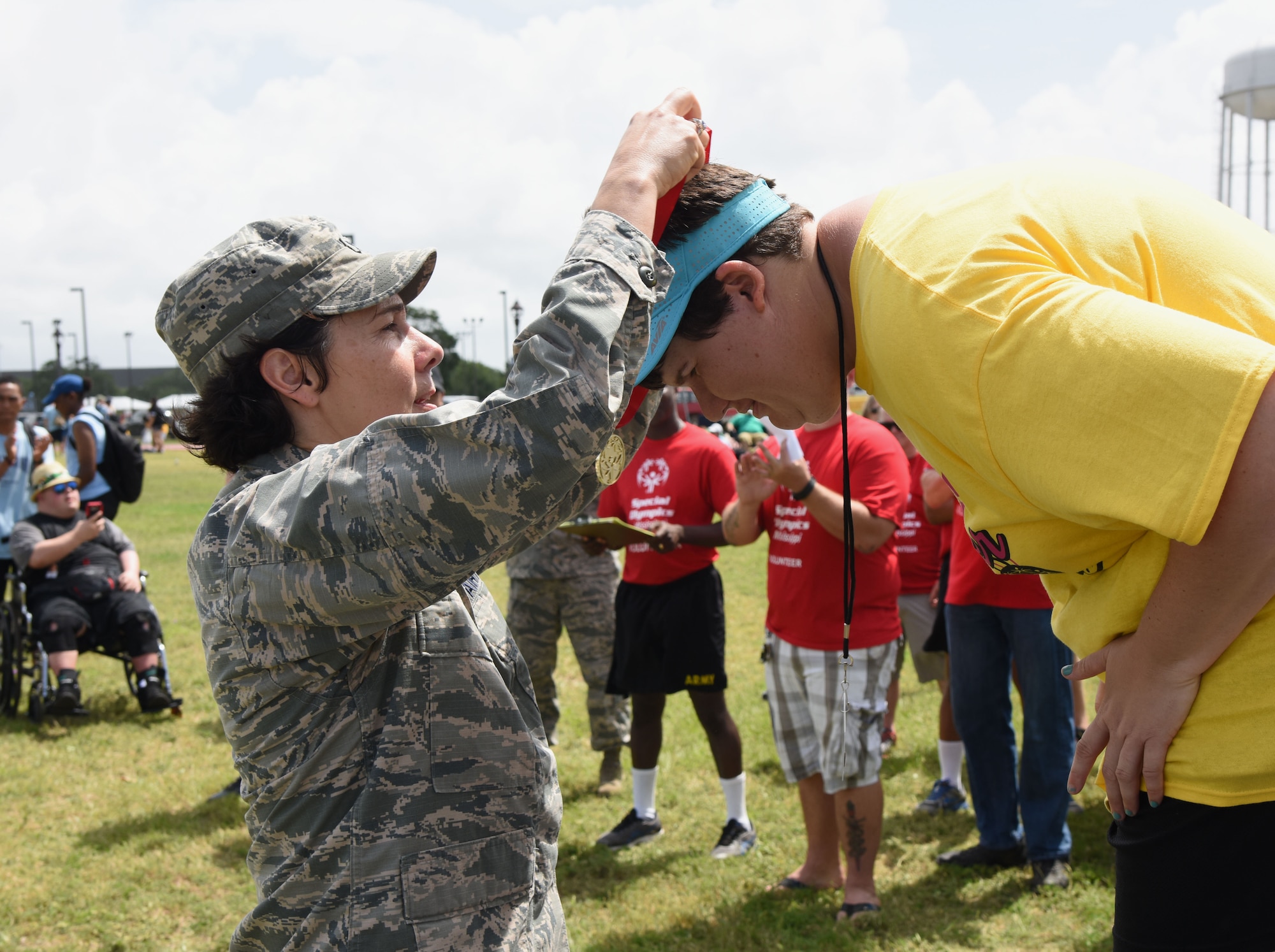 Col. Jeannine Ryder, 81st Medical Group commander, presents a medal to Jennifer Didlake, Area 17 athlete, during the Special Olympics Mississippi 2017 Summer Games May 20, 2017, on Keesler Air Force Base, Miss. Founded in 1968, Special Olympics hosts sporting events around the world for people of all ages with special needs to include more than 700 athletes from Mississippi. (U.S. Air Force photo by Kemberly Groue) 