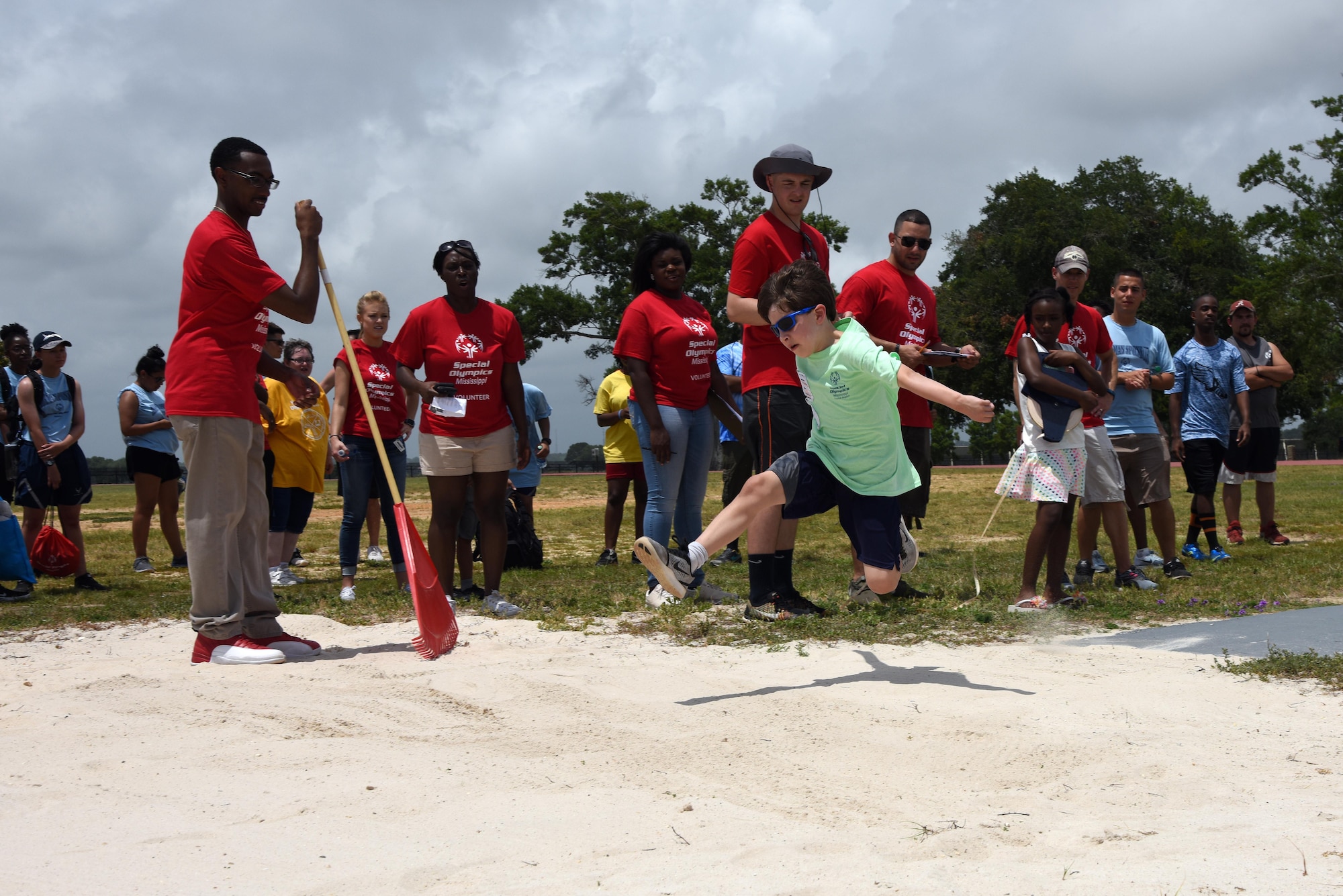 Mikey Balfour, Area 8 athlete, leaps into the air in the running long jump event during the Special Olympics Mississippi 2017 Summer Games May 20, 2017, on Keesler Air Force Base, Miss. Founded in 1968, Special Olympics hosts sporting events around the world for people of all ages with special needs to include more than 700 athletes from Mississippi. (U.S. Air Force photo by Kemberly Groue) 