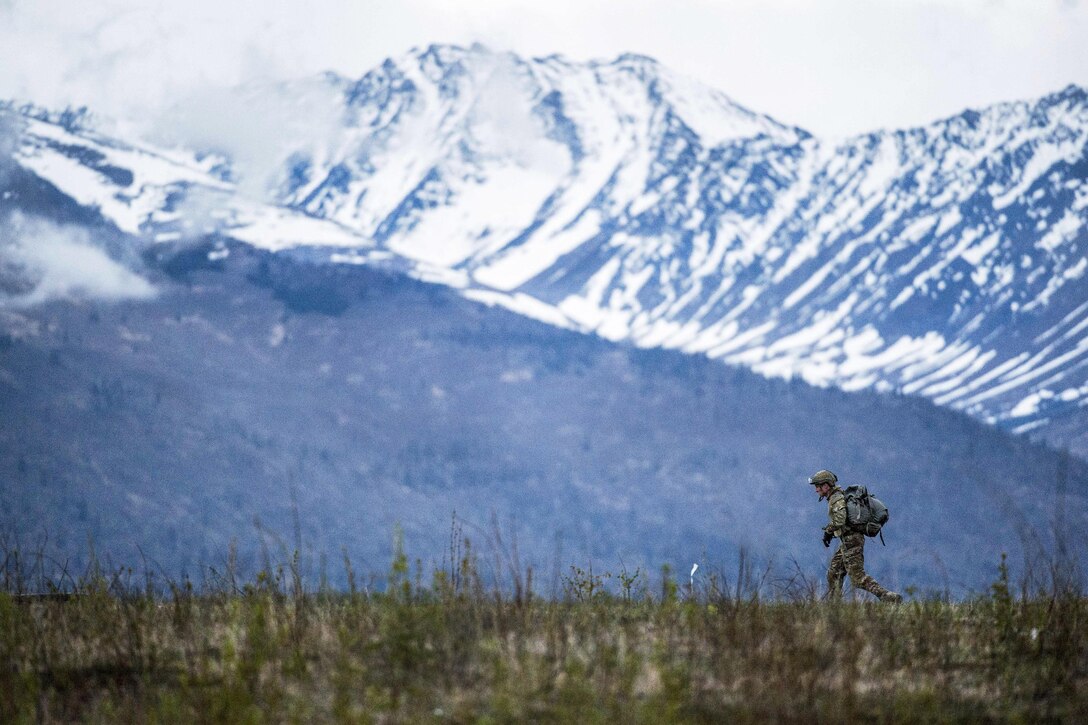 An Air Force tactical air control party specialist proceeds to a rally point after conducting airborne jump training at the Malemute drop zone at Joint Base Elmendorf-Richardson, Alaska, May 18, 2017. The airman is assigned to the 3rd Air Support Operations Squadron. Air Force photo by Alejandro Pena