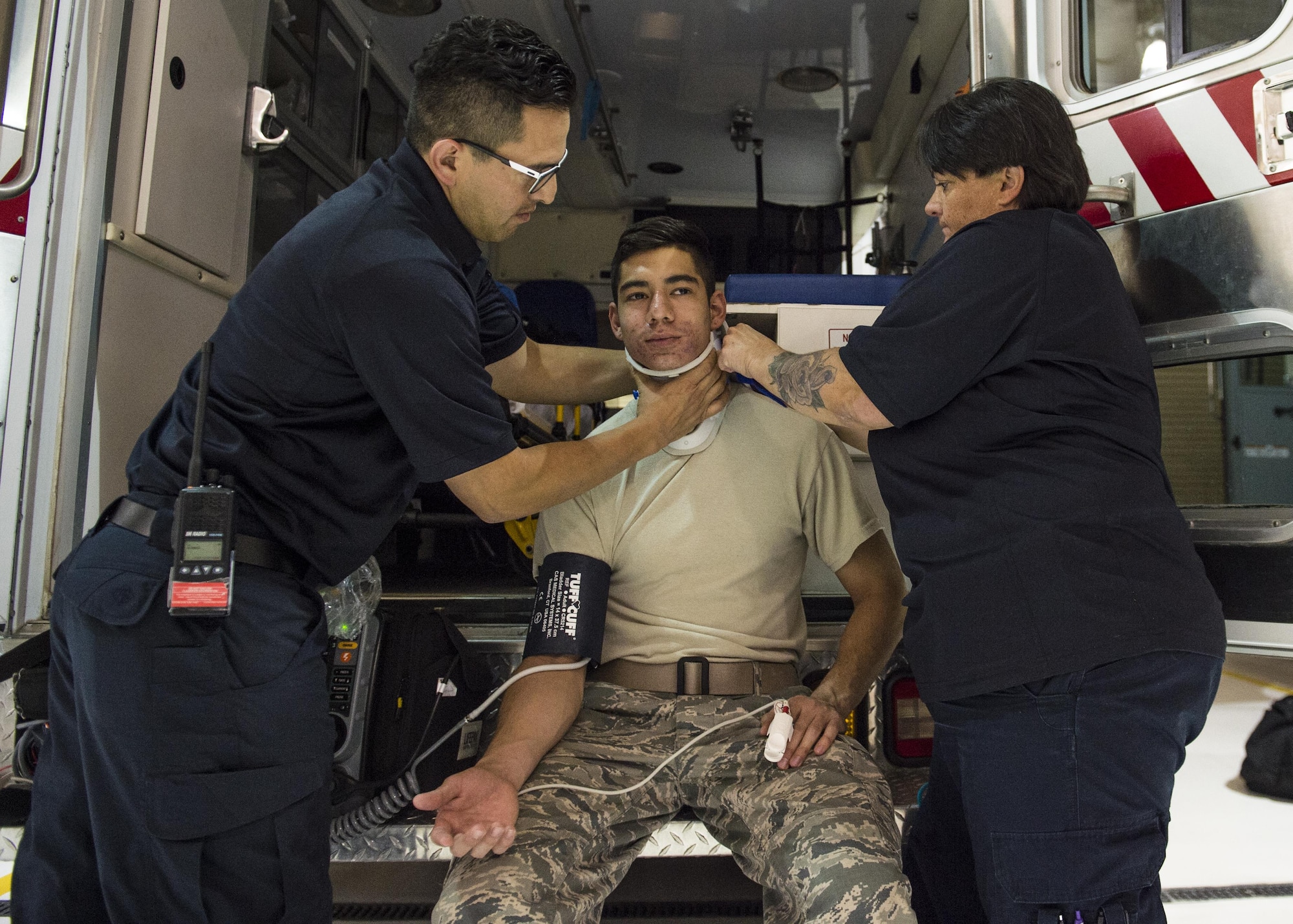 Hector Maldonado, a 49th Medical Operations Squadron emergency medical technician-Intermediate, and Annette Dunlap, the 49th MDOS area project manager and a paramedic, perform an emergency response simulation on a volunteer for National Emergency Medical Services week at Holloman Air Force Base, N.M. on May 18, 2017. National EMS week was established in 1974, as a means to honor EMS practitioners and their contributions to families and communities across the United States. Holloman’s EMS practitioners work 24-hour shifts. The most basic function of their job involves responding to 911 and flight line emergencies. (U.S. Air Force photo by Airman 1st Class Alexis P. Docherty)