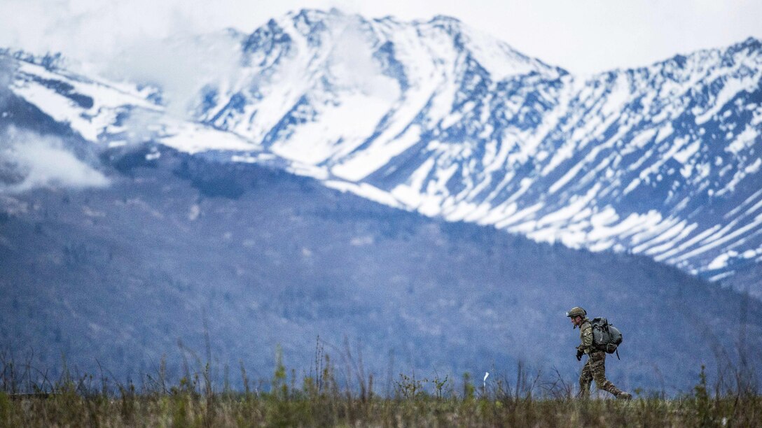 An Air Force tactical air control party specialist proceeds to a rally point after conducting airborne jump training at the Malemute drop zone at Joint Base Elmendorf-Richardson, Alaska, May 18, 2017. The airman is assigned to the 3rd Air Support Operations Squadron. Air Force photo by Alejandro Pena