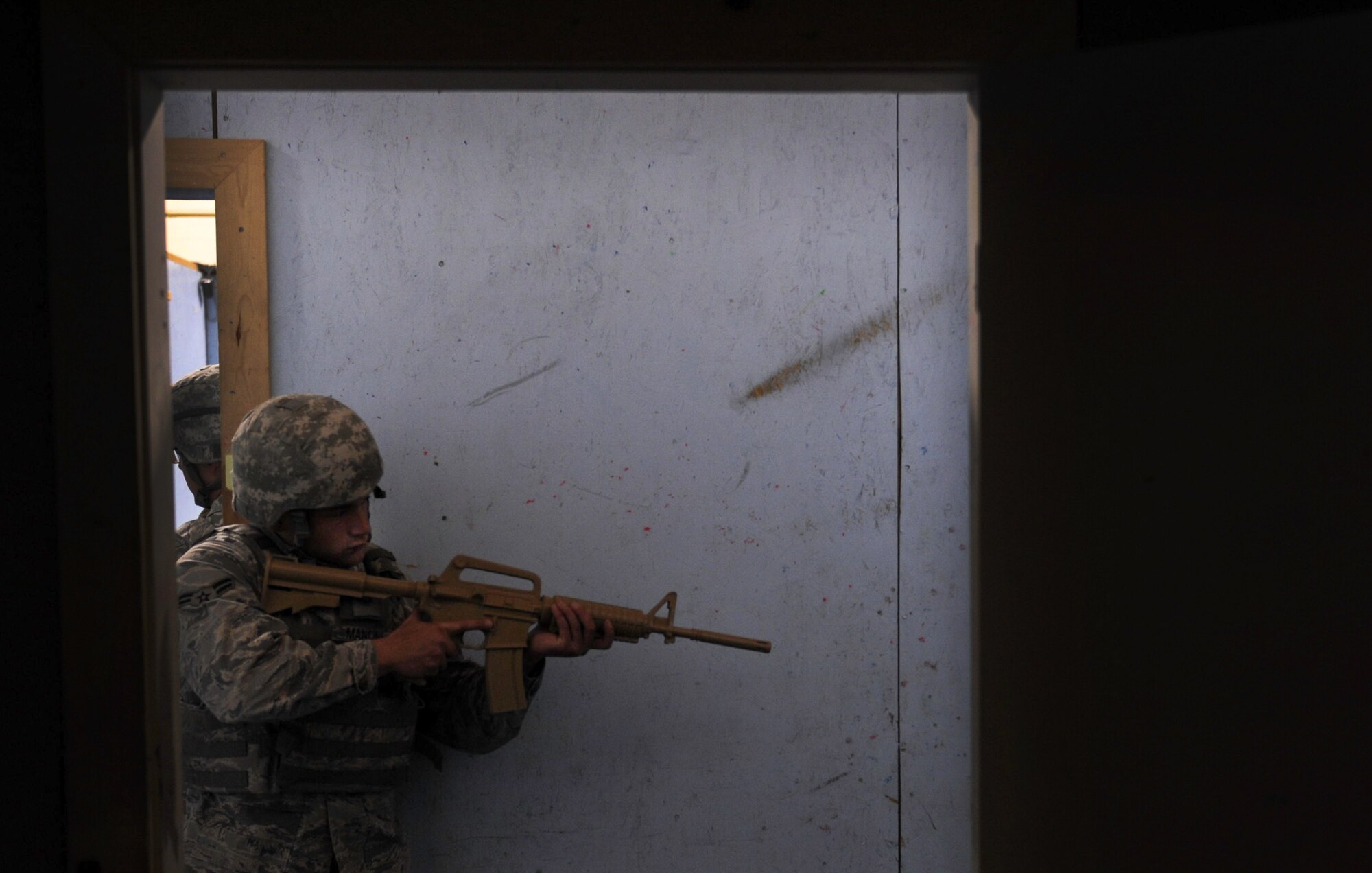 Airman 1st Class Benedetto Mancini, 99th Security Forces Squadron member, covers the rear of a rescue team in a hallway during a training scenario in Area II on Nellis Air Force Base, Nev., May 17, 2017. The exercise was designed to prepare and test the response efforts of SFS Airmen in the event of a dangerous situation. (U.S. Air Force photo by Senior Airman Kevin Tanenbaum/Released)