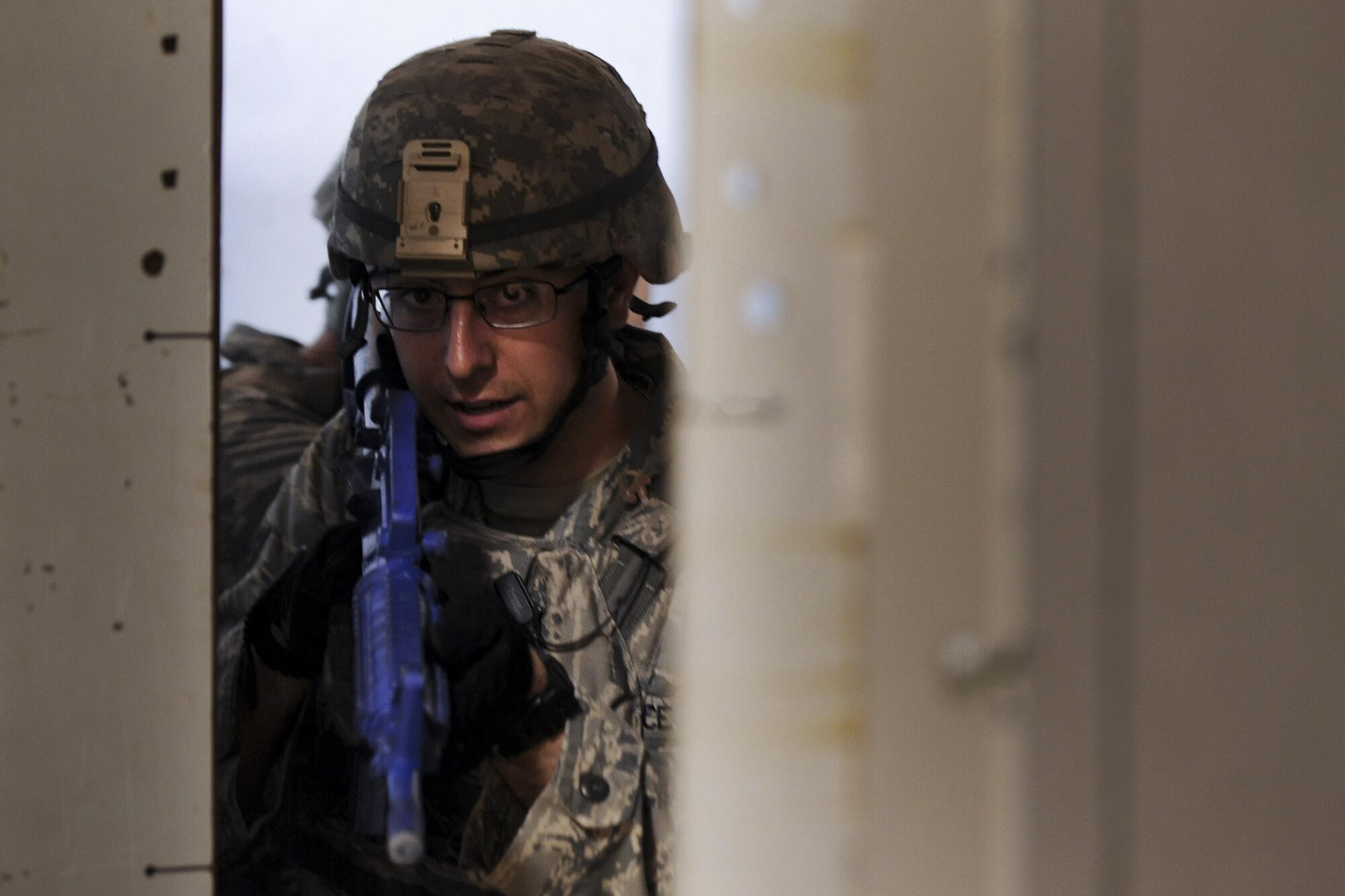 Staff Sgt. Kenneth Delongchamp, 99th Security Forces Squadron member, prepares to enter a doorway during a training scenario in Area II on Nellis Air Force Base, Nev., May 17, 2017. The 99th SFS designs realistic exercises to keep Airmen in a warrior mindset and sharpen tactics, techniques and procedures to prevent unnecessary loss of life and injuries in the event of a real-world incident. (U.S. Air Force photo by Senior Airman Kevin Tanenbaum/Released)