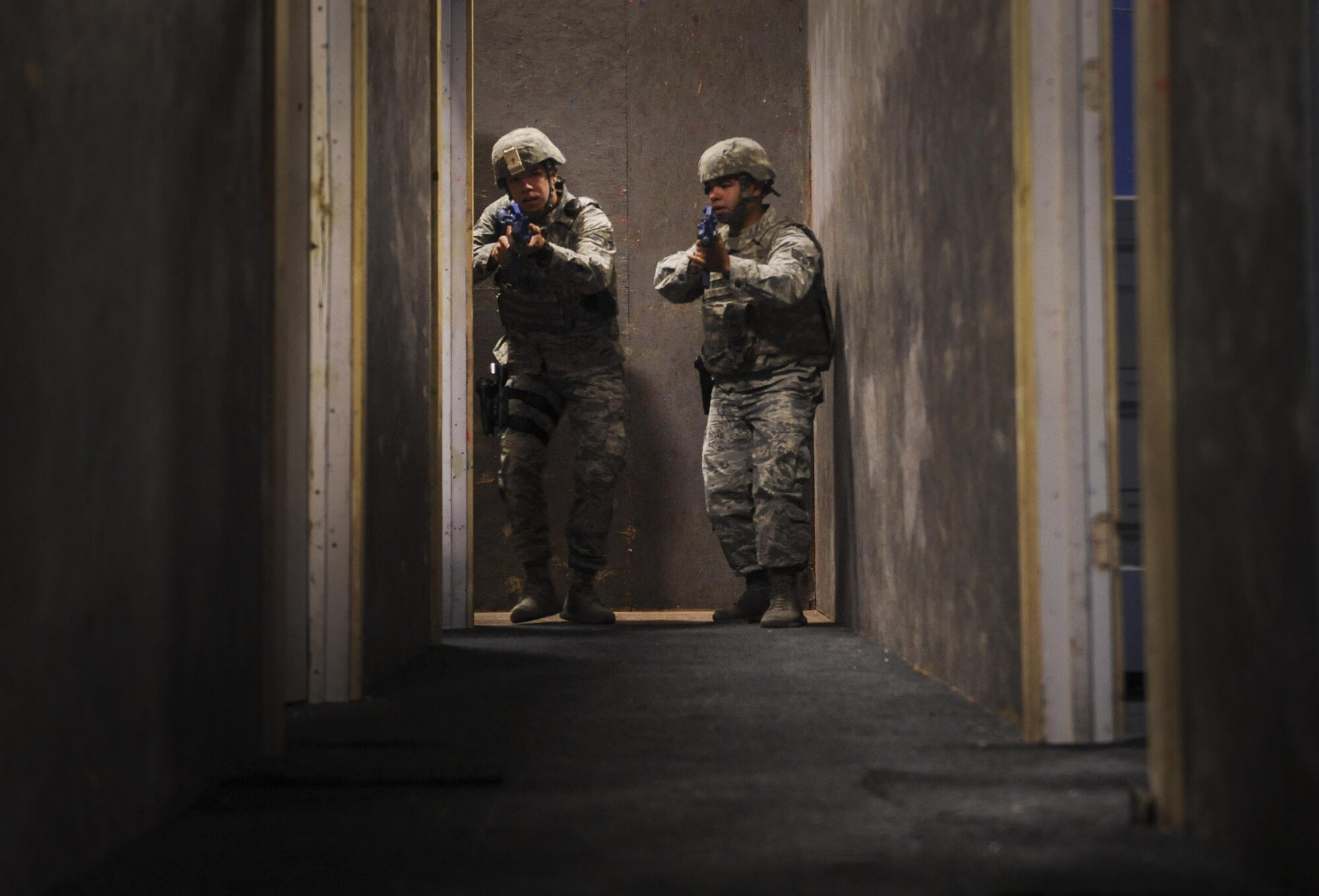 Senior Airman Jesus Guerrero and Airman 1st Class Emilio Rodriguez, 99th Security Forces Squadron members, clear rooms during an active-shooter training scenario in Area II on Nellis Air Force Base, Nev., May 17, 2017. All law enforcement and security response team patrols need to be capable to respond to a variety of emergencies. (U.S. Air Force photo by Senior Airman Kevin Tanenbaum/Released)