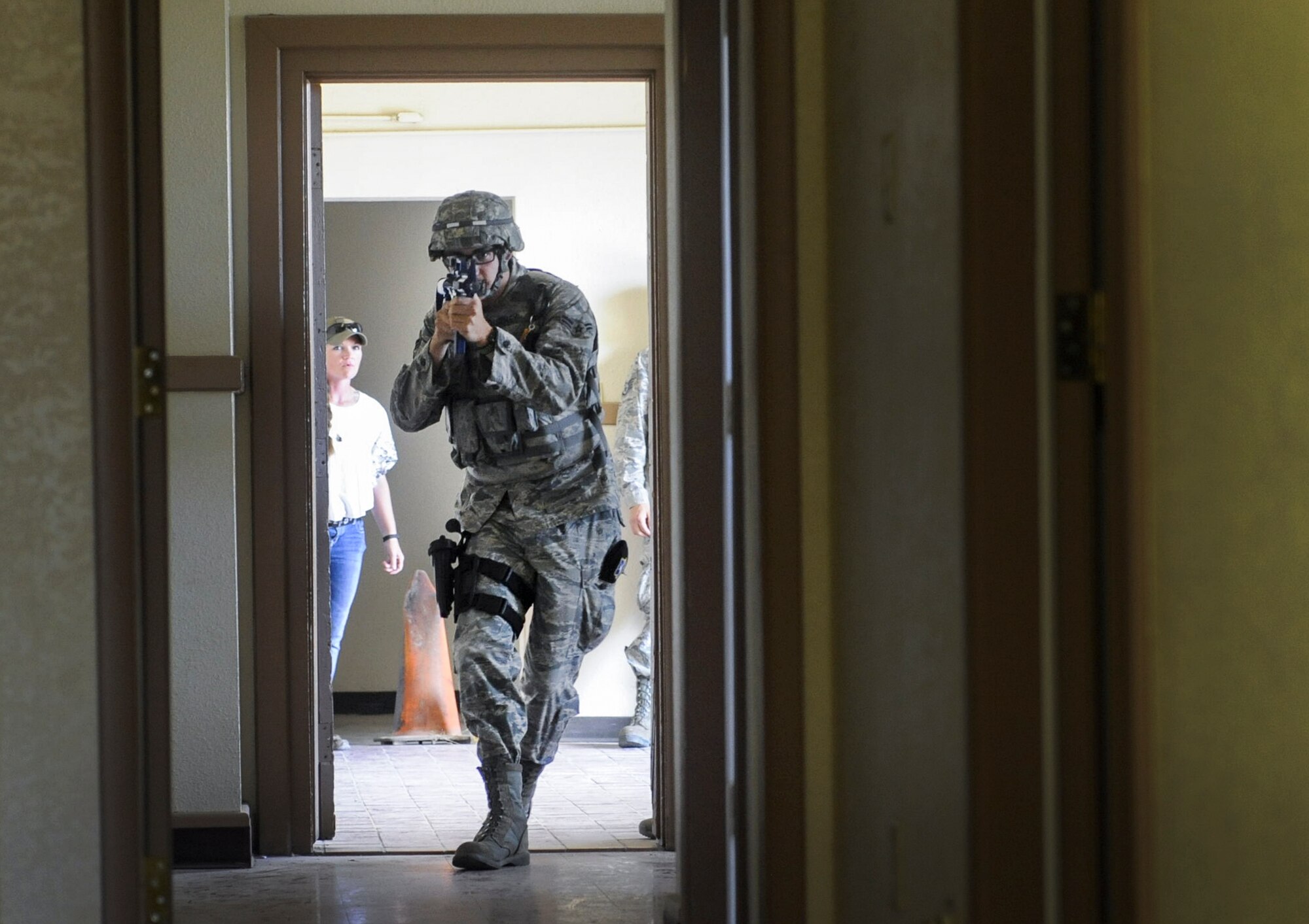 Airman 1st Class Nicolus Thompson, 99th Security Forces Squadron member, enters a simulated active shooter scenario in Area II on Nellis Air Force Base, Nev., May 17, 2017. Defenders of the 99th SFS immediately followed established procedures to respond to and neutralize the simulated threat. (U.S. Air Force photo by Senior Airman Kevin Tanenbaum/Released)