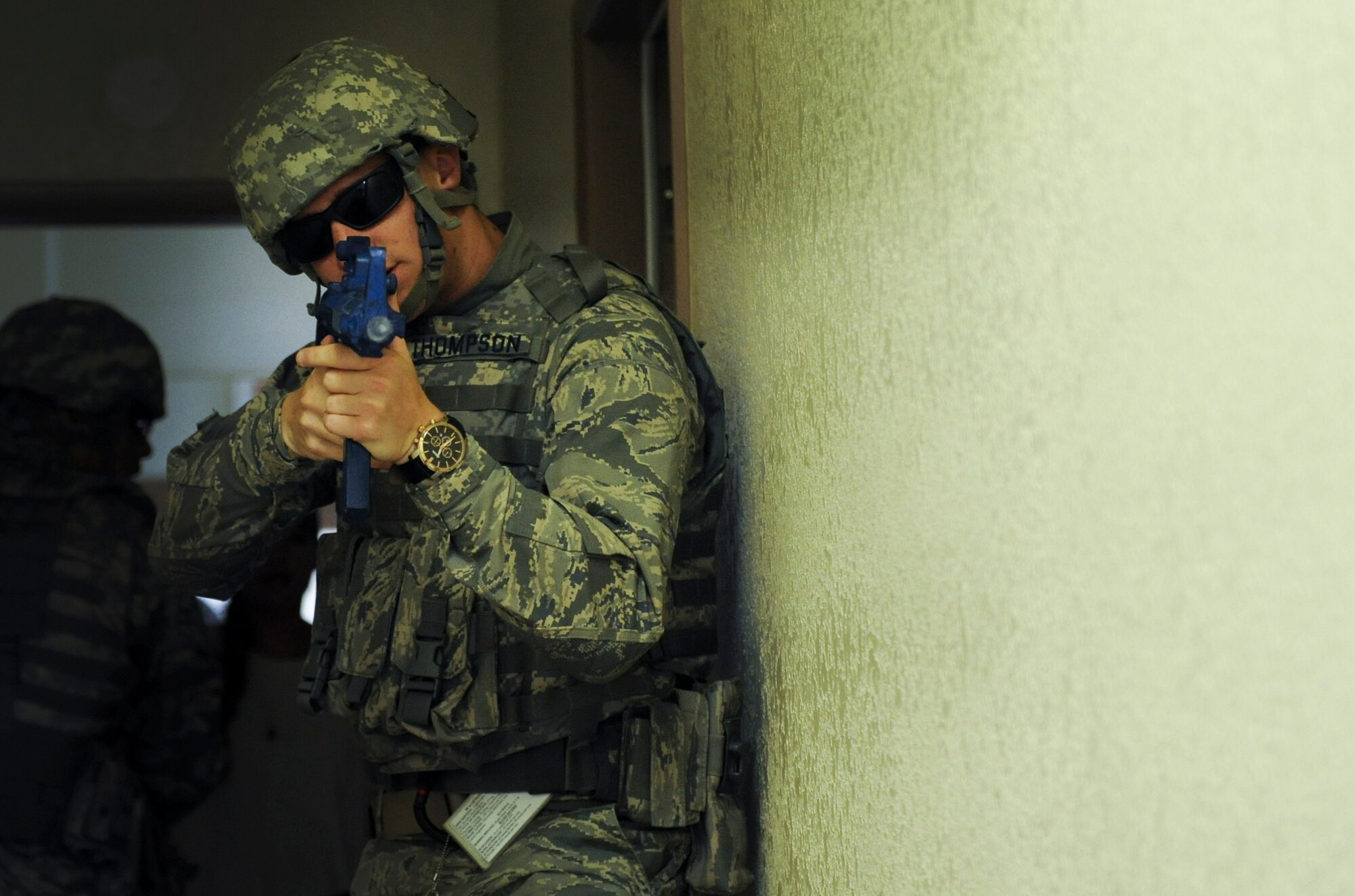 Airman 1st Class Nicolus Thompson, 99th Security Forces Squadron member, covers the front of a formation during a simulated active-shooter scenario in Area II on Nellis Air Force Base, Nev., May 17, 2017. The 99th SFS provides flight line security, police services, antiterrorism and force protection for Nellis and Creech AFBs. (U.S. Air Force photo by Senior Airman Kevin Tanenbaum/Released)