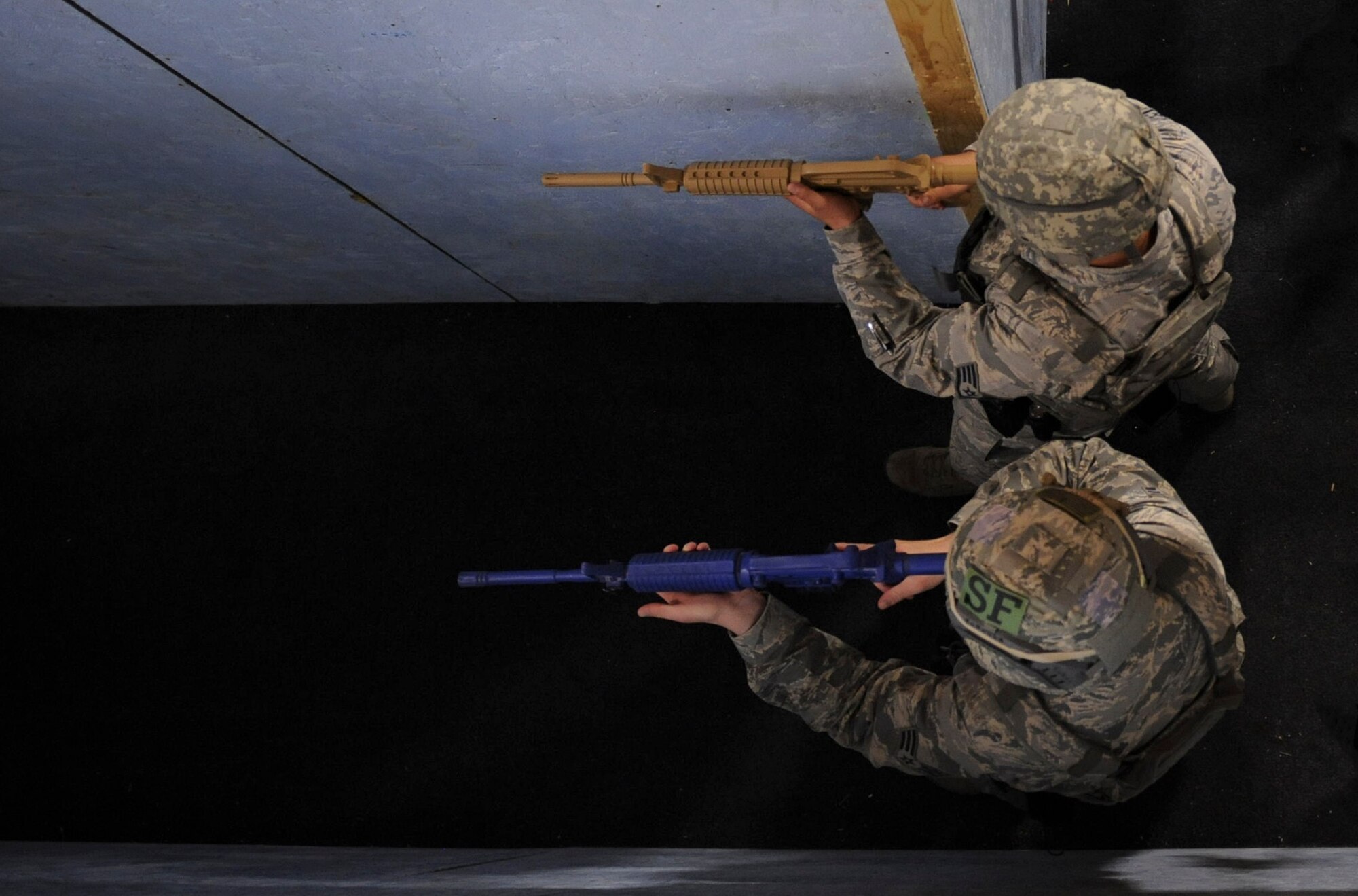 99th Security Forces Squadron Airmen clear rooms during a rescue scenario with fire protection in Area II on Nellis Air Force Base, Nev., May 17, 2017. Security forces members provide base defense and protection, and respond to scenarios ranging from routine traffic stops to active-shooter scenarios. (U.S. Air Force photo by Senior Airman Kevin Tanenbaum/Released)