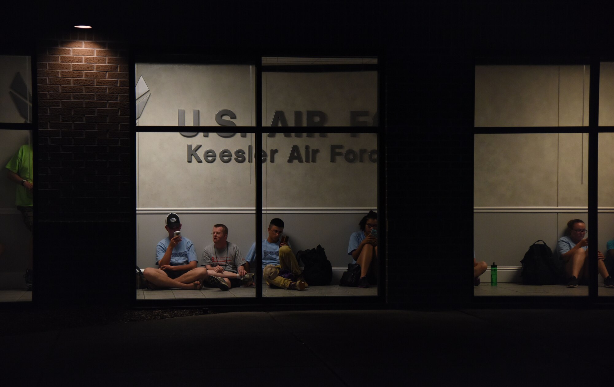 Airmen sponsors and athletes wait in the hallway for the weather to clear at the Levitow Training Support Facility during the Special Olympics Mississippi 2017 Summer Games closing ceremony May 20, 2017, on Keesler Air Force Base, Miss. Founded in 1968, Special Olympics hosts sporting events around the world for people of all ages with special needs to include more than 700 athletes from Mississippi. (U.S. Air Force photo by Kemberly Groue)