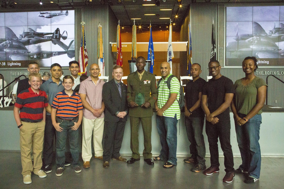Sgt. Juvante Butler (center), an administrative specialist with 4th Marine Division, Marine Forces Reserve, and members of the Knights of Pythagoras pose for a photo at the World War II Museum in New Orleans, May 20, 2017. The Knights of Pythagoras is a mentorship program created to help council young men in the New Orleans community. (U.S. Marine Corps photo by Pfc. Melany Vasquez / Released)